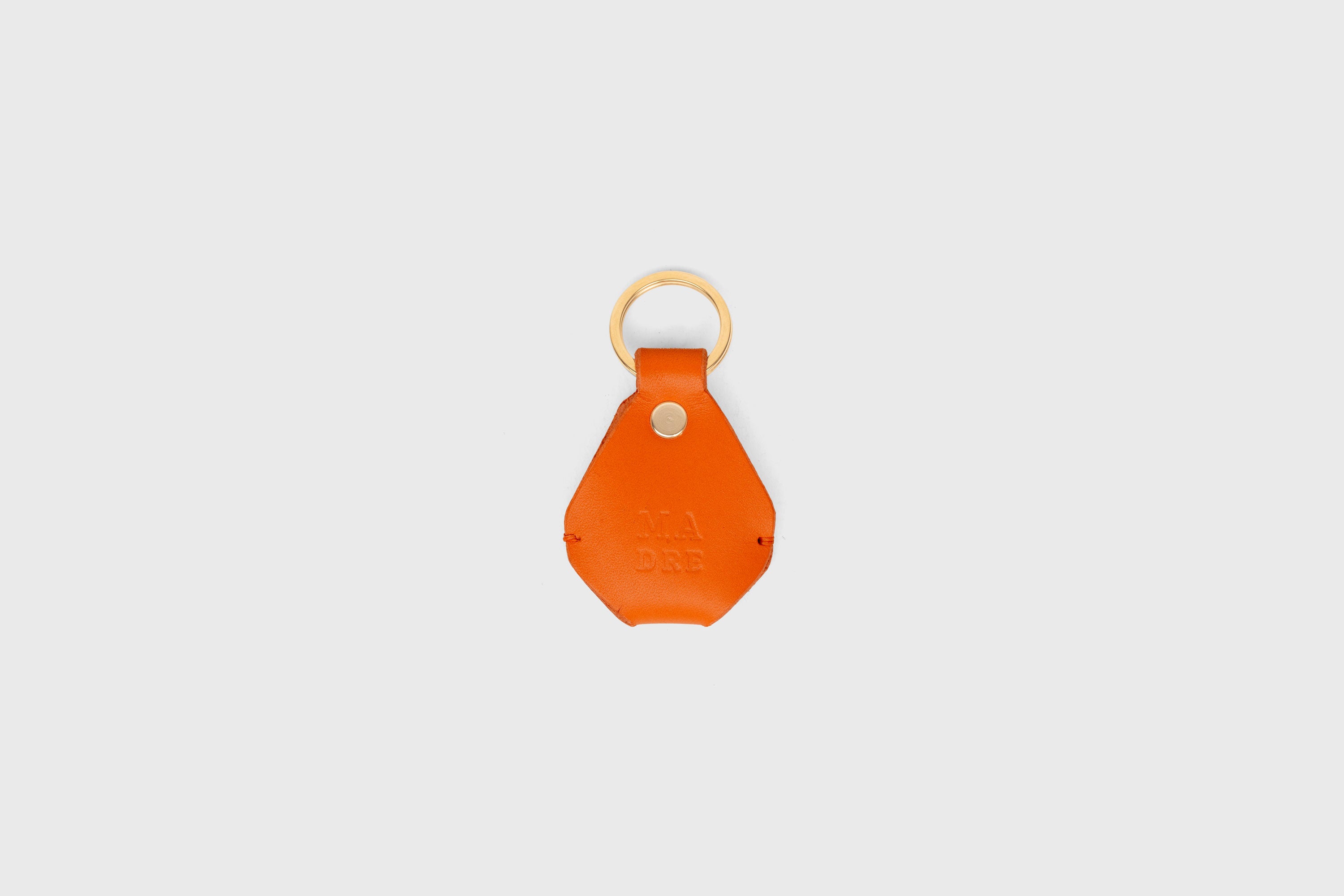 Airtag Key Ring In Orange Color In Vegetable Tanned Leather Minimalistic Design Atelier Madre Manuel Dreesmann Barcelona Spain