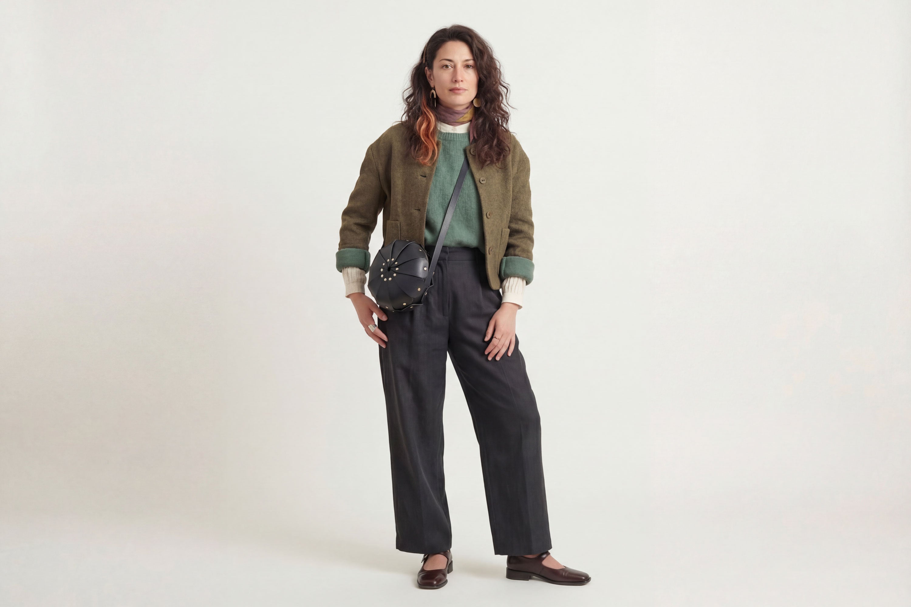 Anemo Leather Bag Black Color On A Woman Model Floral Design Premium Minimalist Modern Circle Round Pouch Crossbody Atelier Madre Manuel Dreesmann Barcelona Spain