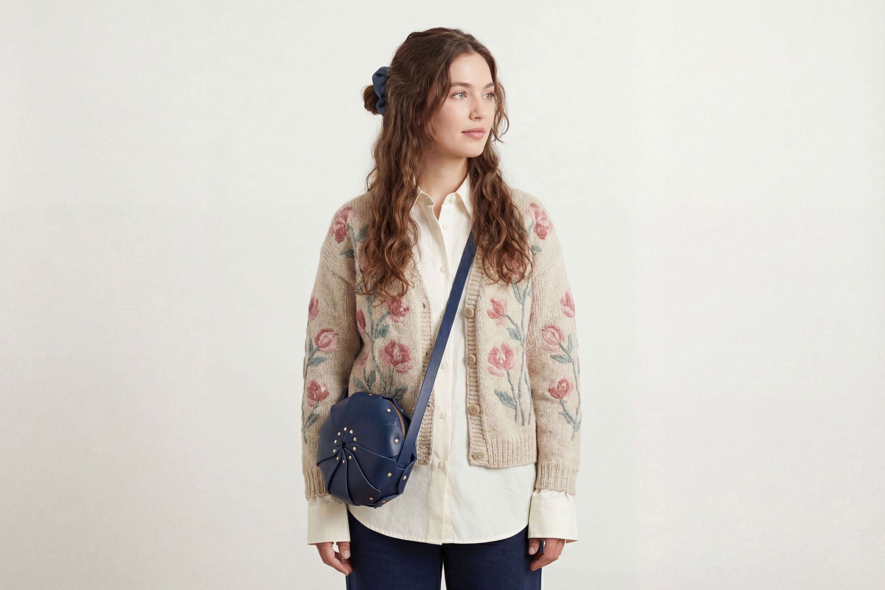 Anemo Leather Bag Marine Blue Color On A Woman Model Floral Design Premium Minimalist Modern Circle Round Pouch Crossbody Atelier Madre Manuel Dreesmann Barcelona Spain