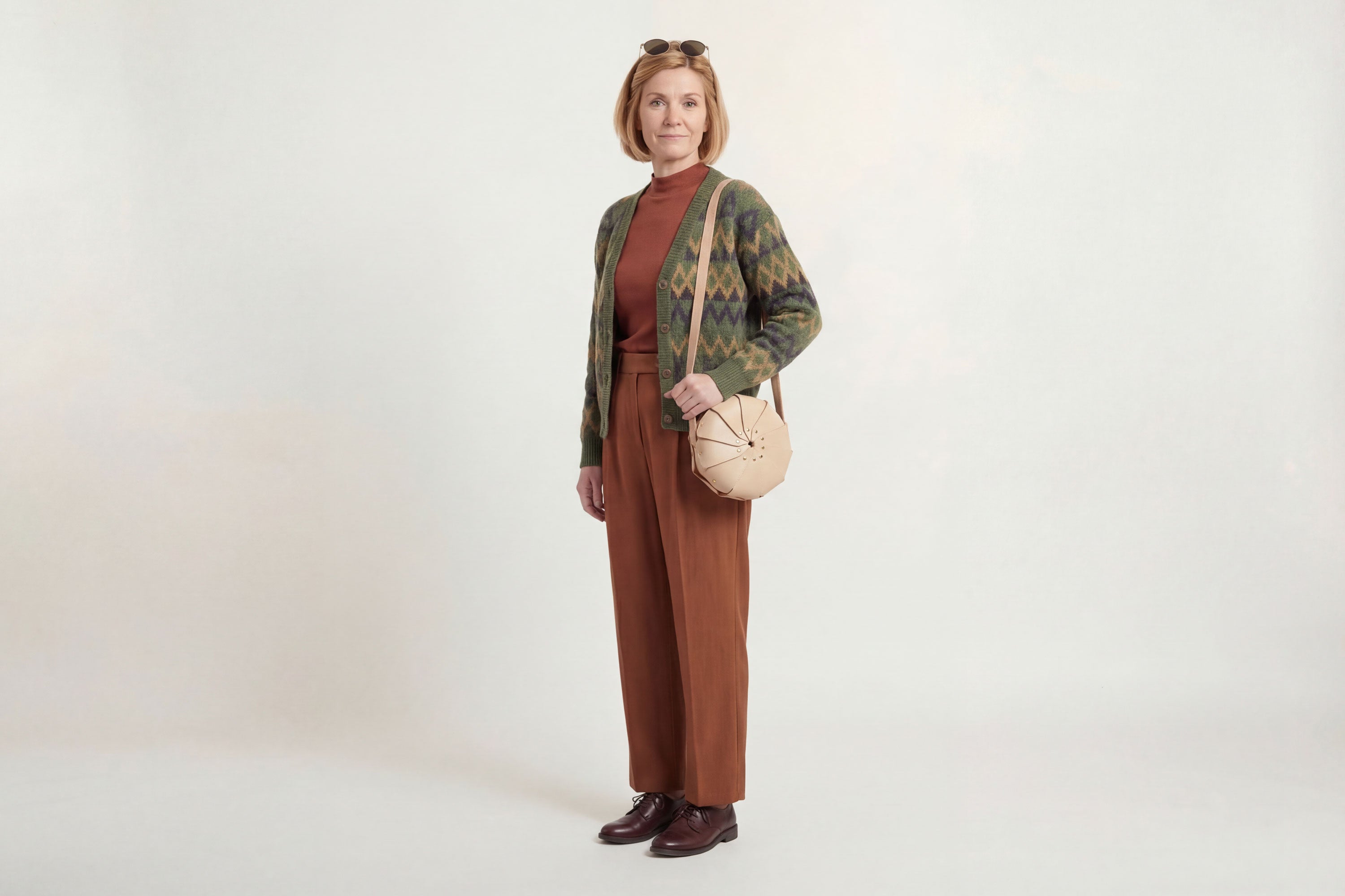 Anemo Leather Bag Natural Color On A Woman Model Floral Design Premium Minimalist Modern Circle Round Pouch Crossbody Atelier Madre Manuel Dreesmann Barcelona Spain