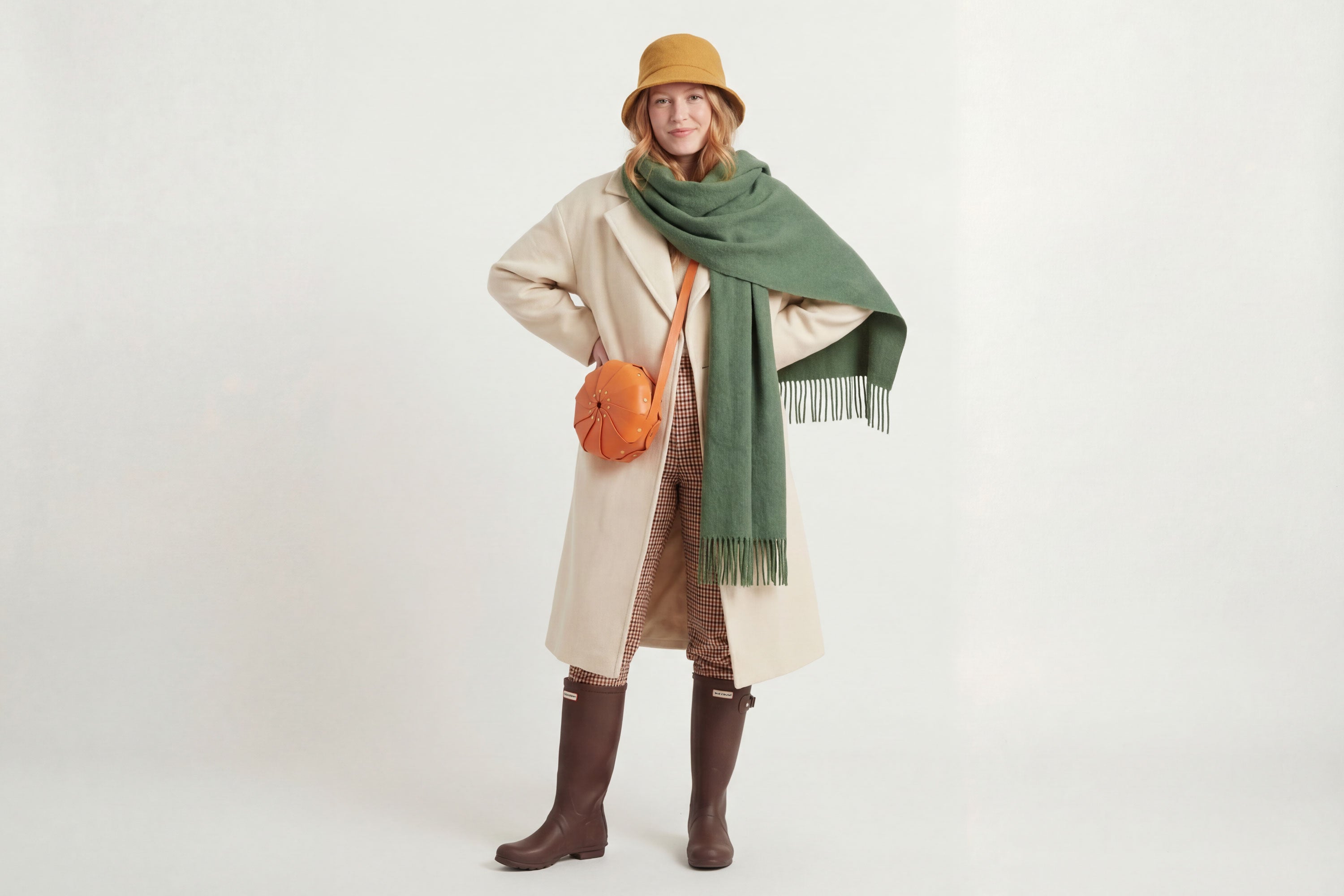 Anemo Leather Bag Orange Color On A Woman Model Floral Design Premium Minimalist Modern Circle Round Pouch Crossbody Atelier Madre Manuel Dreesmann Barcelona Spain