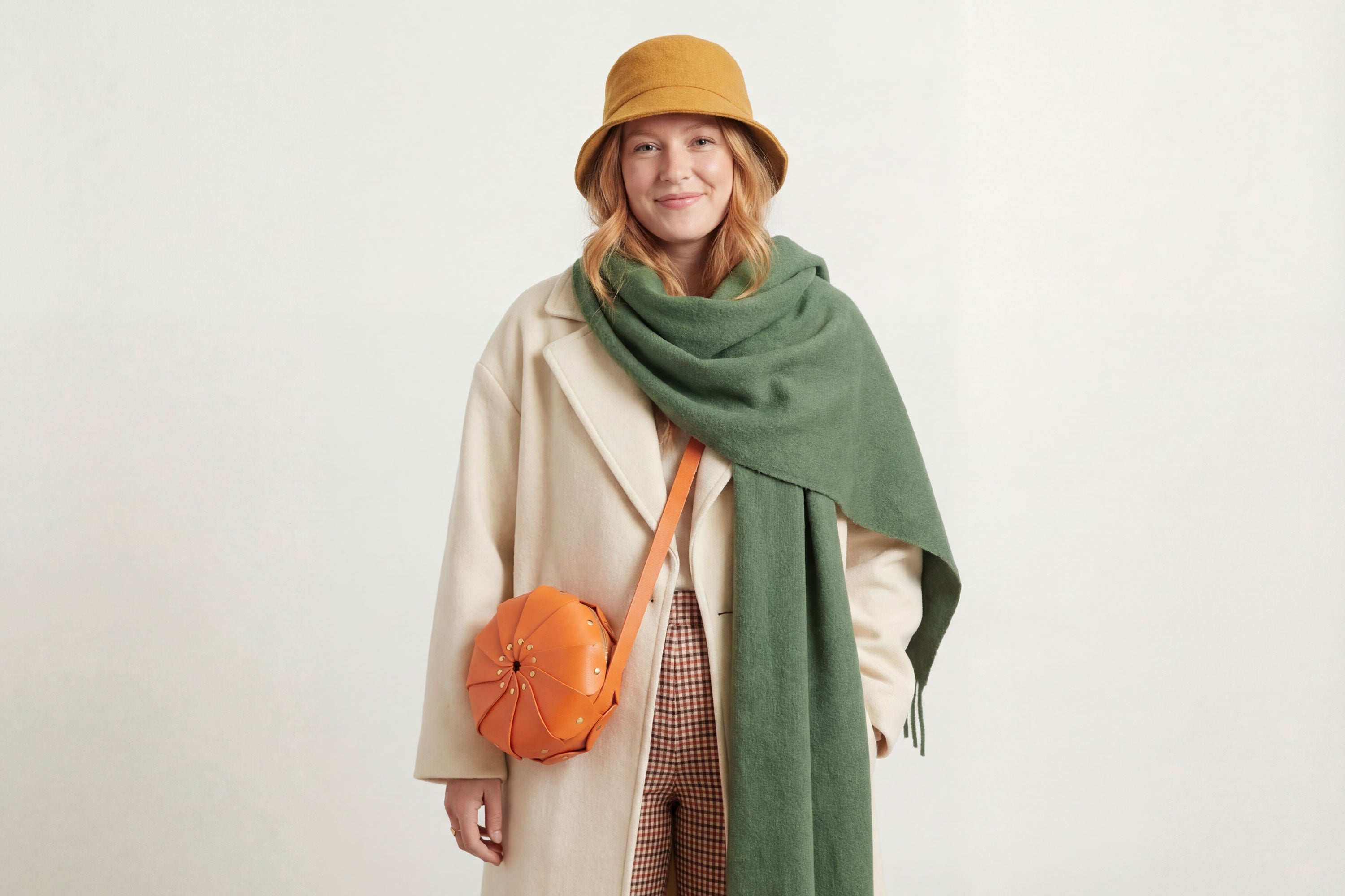 Anemo Leather Bag Orange Color On A Woman Model Floral Design Premium Minimalist Modern Circle Round Pouch Crossbody Atelier Madre Manuel Dreesmann Barcelona Spain