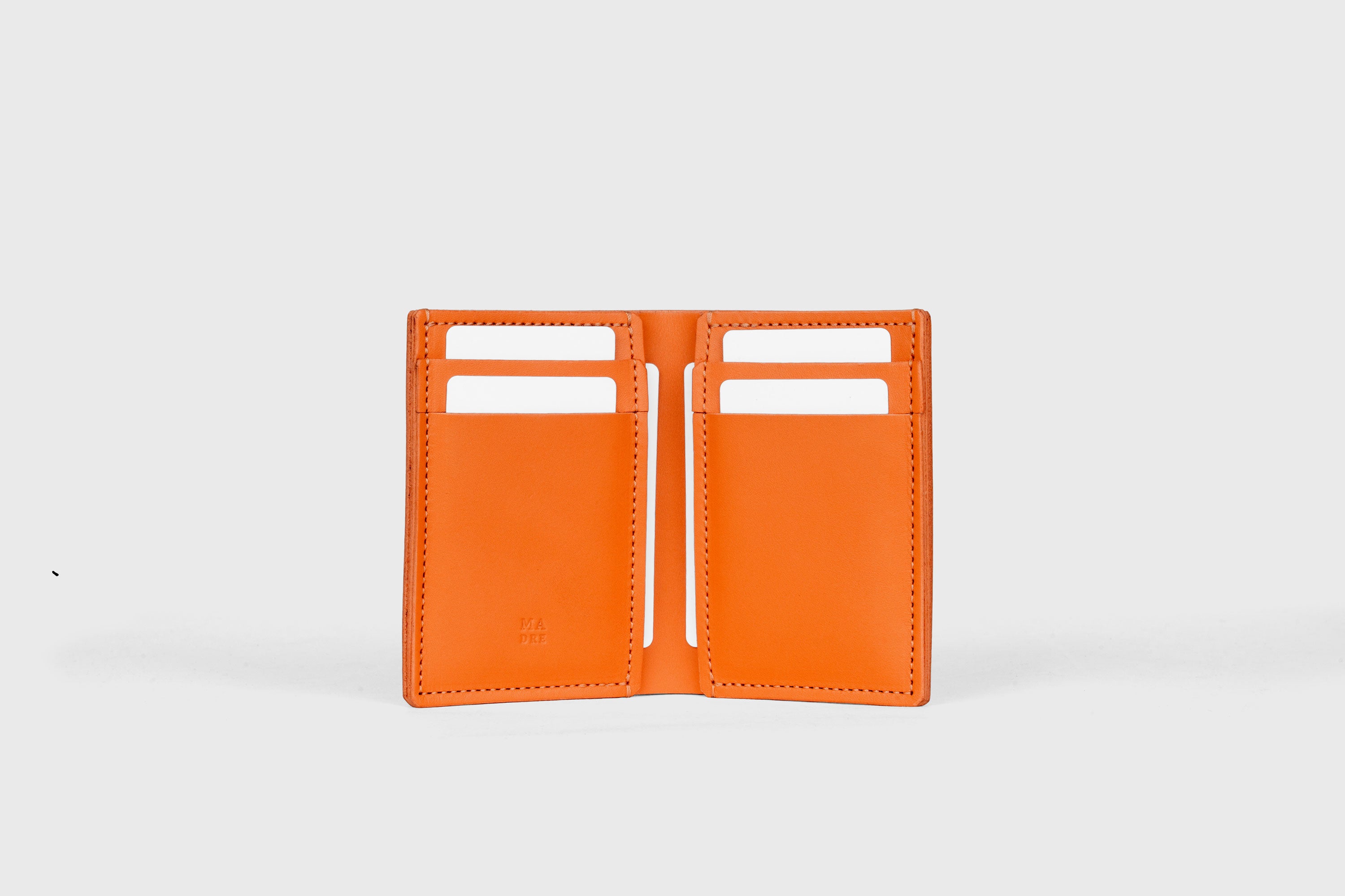 Bifold Wallet Vertical 6 Slots In Orange Color In Vegetable Tanned Leather Minimalistic Design Atelier Madre Manuel Dreesmann Barcelona Spain