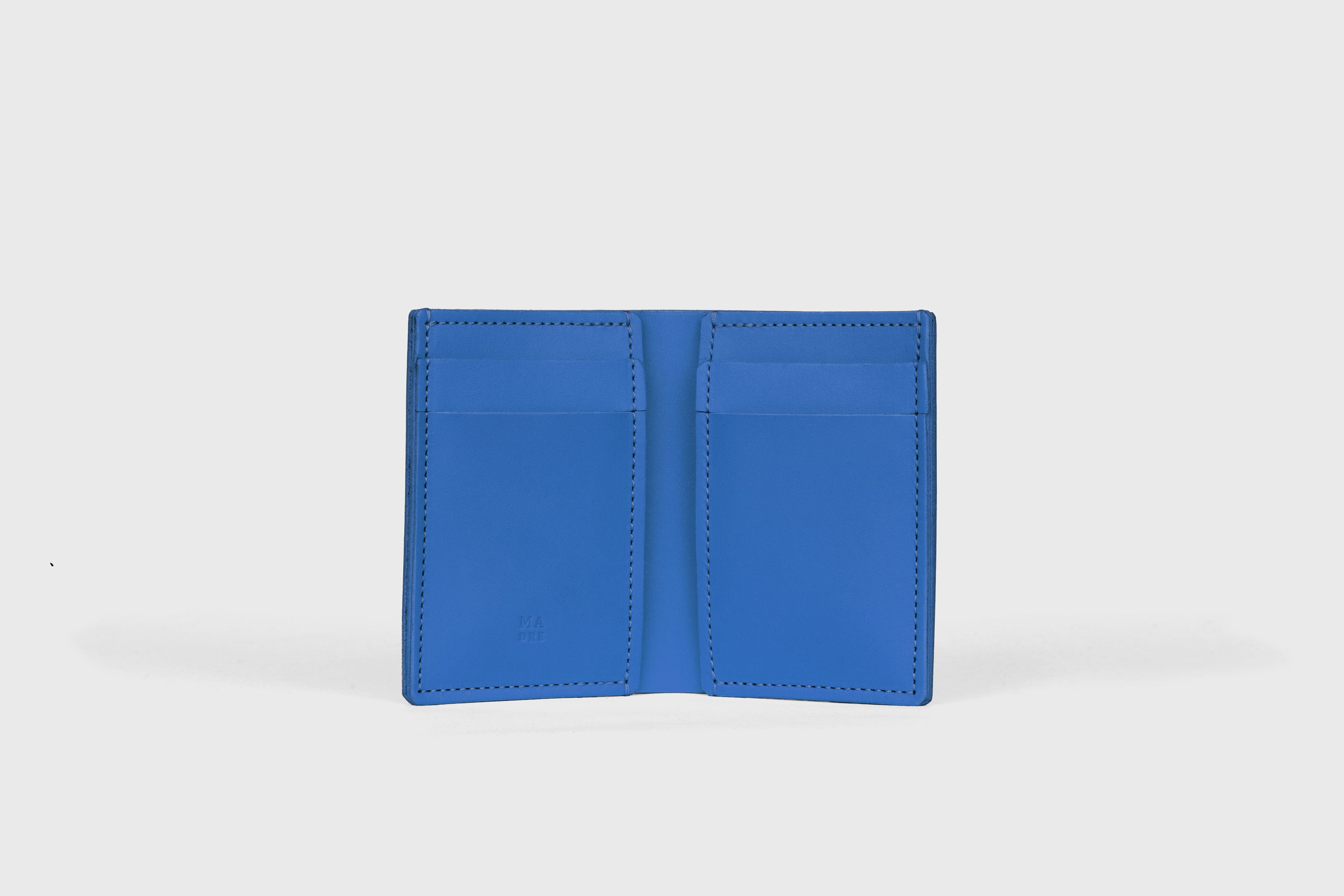Bifold Wallet Vertical 6 Slots In Royal Blue Color In Vegetable Tanned Leather Minimalistic Design Atelier Madre Manuel Dreesmann Barcelona Spain