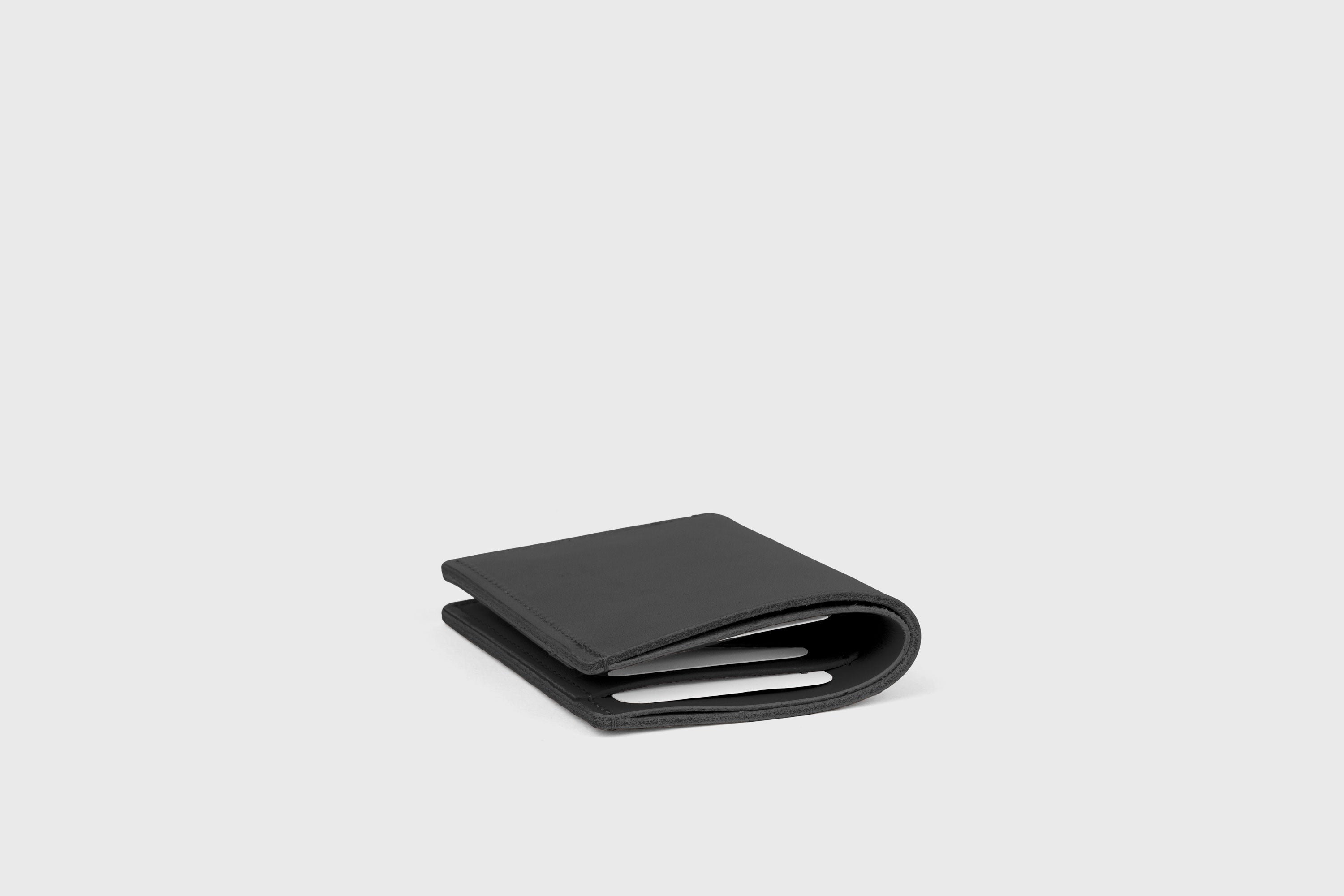 Bifold Wallet Vertical In Black Color In Vegetable Tanned Leather Minimalistic Slim Design Atelier Madre Manuel Dreesmann Barcelona Spain