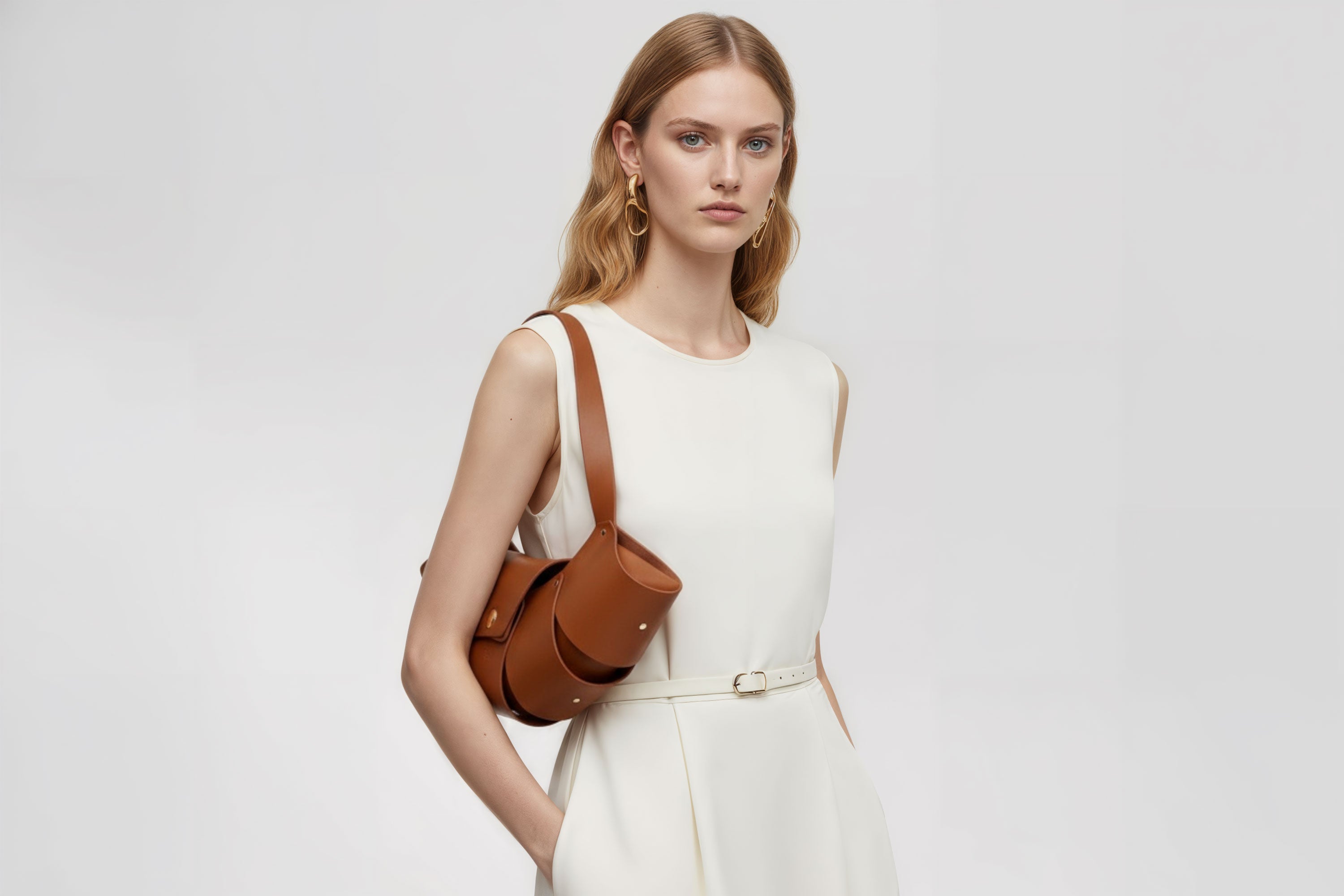 Croissant Bag Big Dark Brown Leather Magnetic Closure On A Woman Model Full Grain Vegetable Tanned Leather High Quality Modern Minimalistic Organic Design Full Brass Rivets Atelier Madre Manuel Dreesmann Barcelona Spain