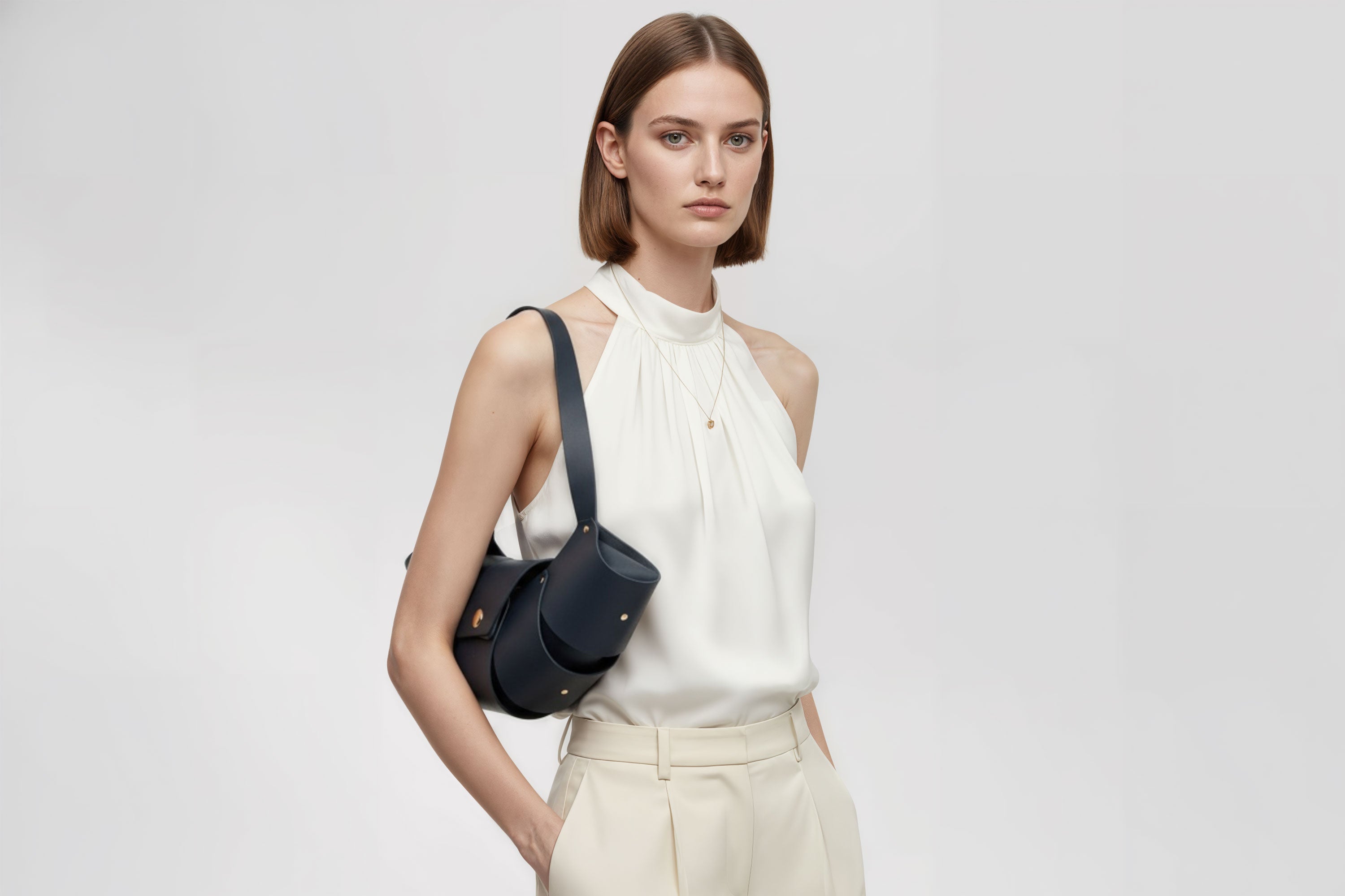 Croissant Bag Big Marine Blue Leather Magnetic Closure On A Woman Model Full Grain Vegetable Tanned Leather High Quality Modern Minimalistic Organic Design Full Brass Rivets Atelier Madre Manuel Dreesmann Barcelona Spain