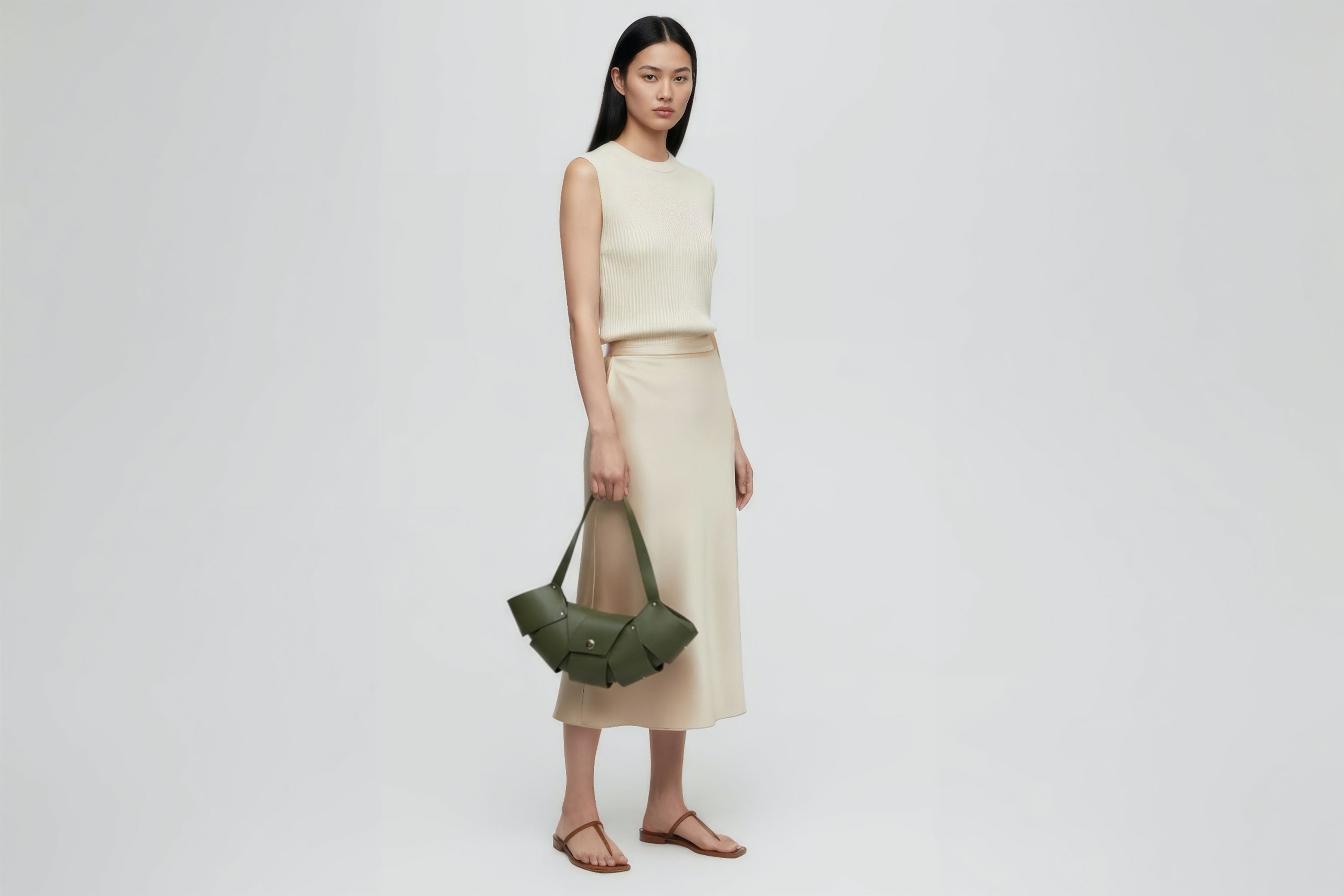 Croissant Bag Big Olive Green Colour Leather Magnetic Closure On A Woman Model Full Grain Vegetable Tanned Leather High Quality Modern Minimalistic Organic Design Full Brass Rivets Atelier Madre Manuel Dreesmann Barcelona Spain