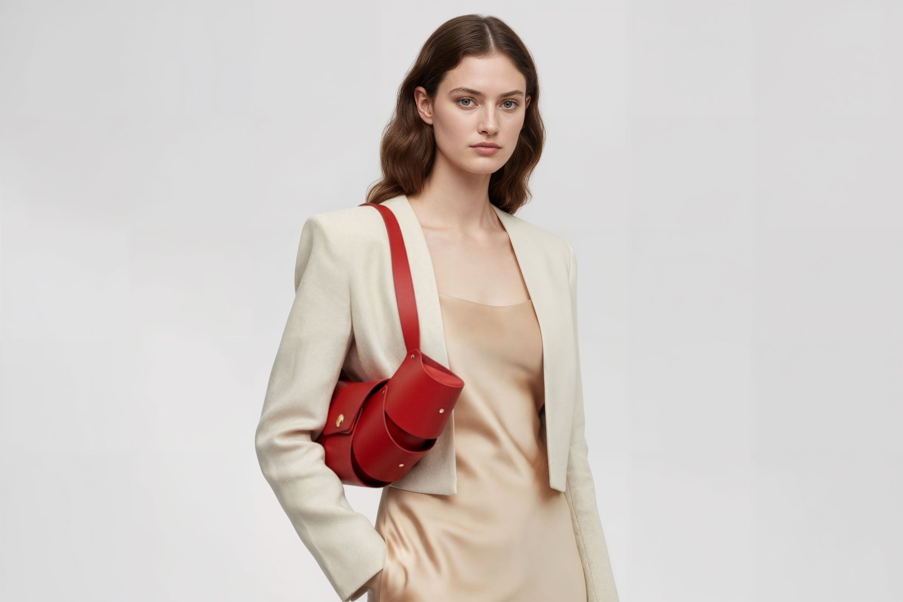 Croissant Bag Big Red Colour Leather Magnetic Closure On A Woman Model Full Grain Vegetable Tanned Leather High Quality Modern Minimalistic Organic Design Full Brass Rivets Atelier Madre Manuel Dreesmann Barcelona Spain