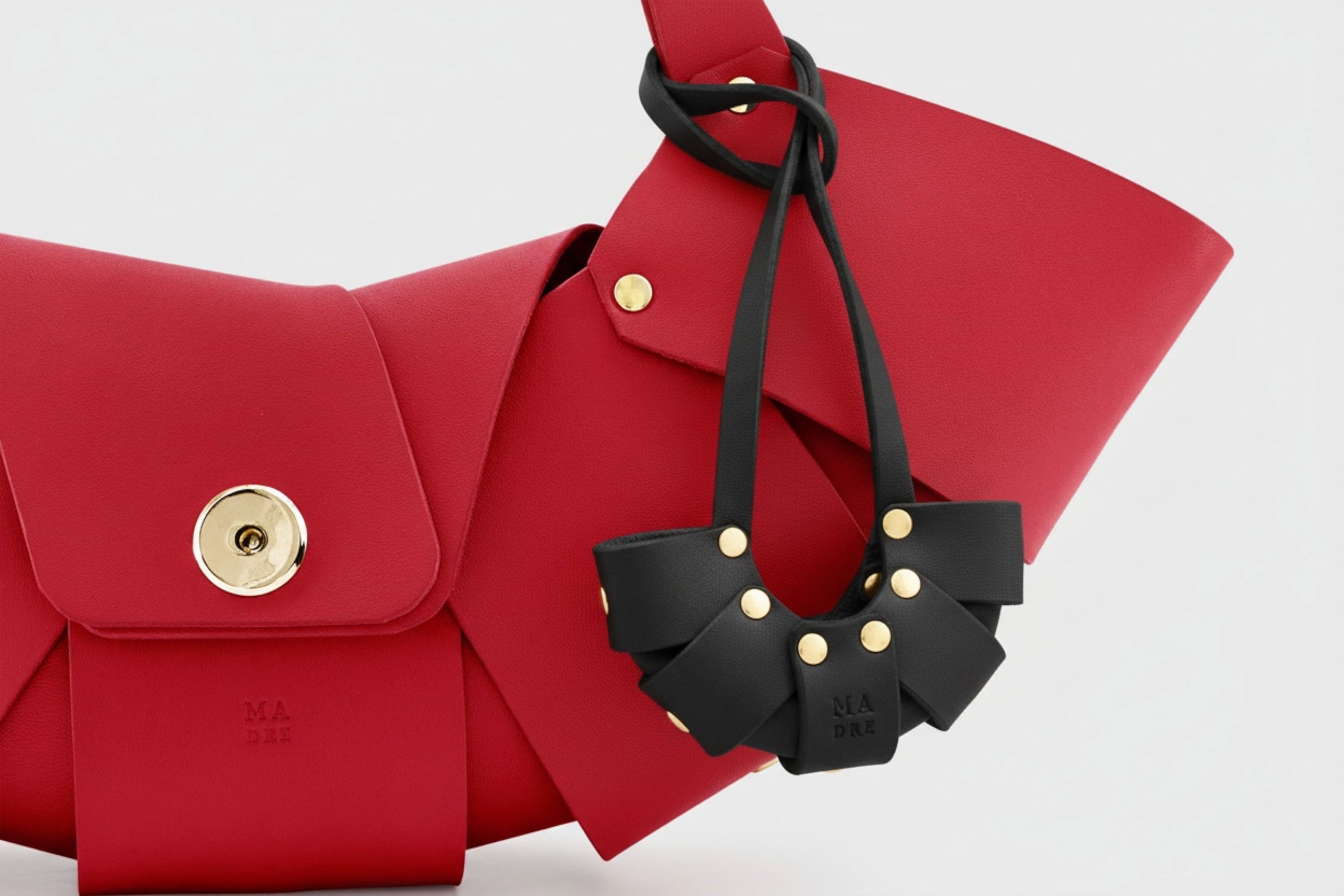 Black Color Leather Croissant Bag Charm Minimal Premium Design on Red Croissant bag attached Atelier Madre Manuel Dreesmann Barcelona Spain