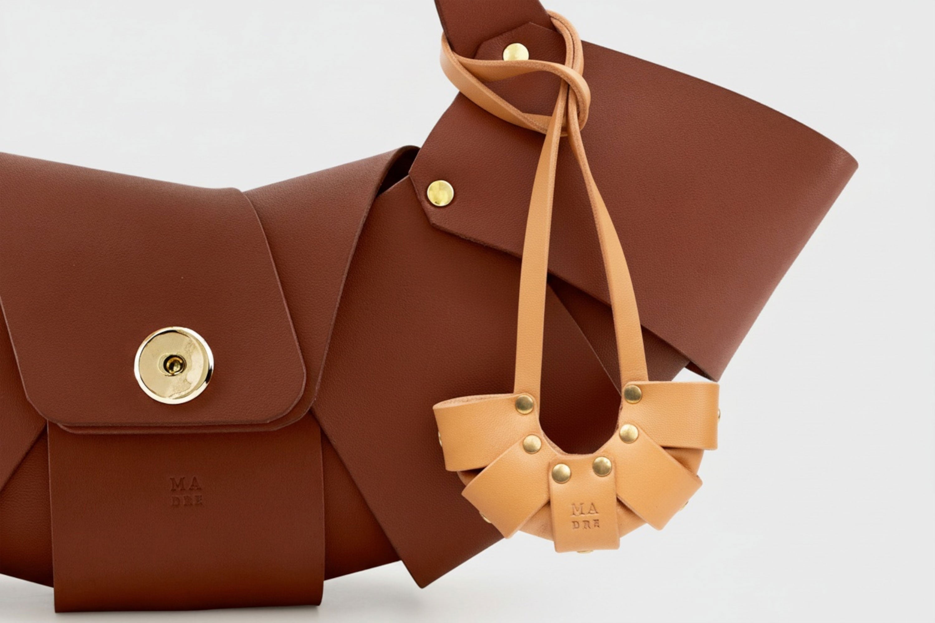 Brown Color Leather Croissant Bag Charm on dark brown croissant bag attached Minimal Premium Design Atelier Madre Manuel Dreesmann Barcelona Spain