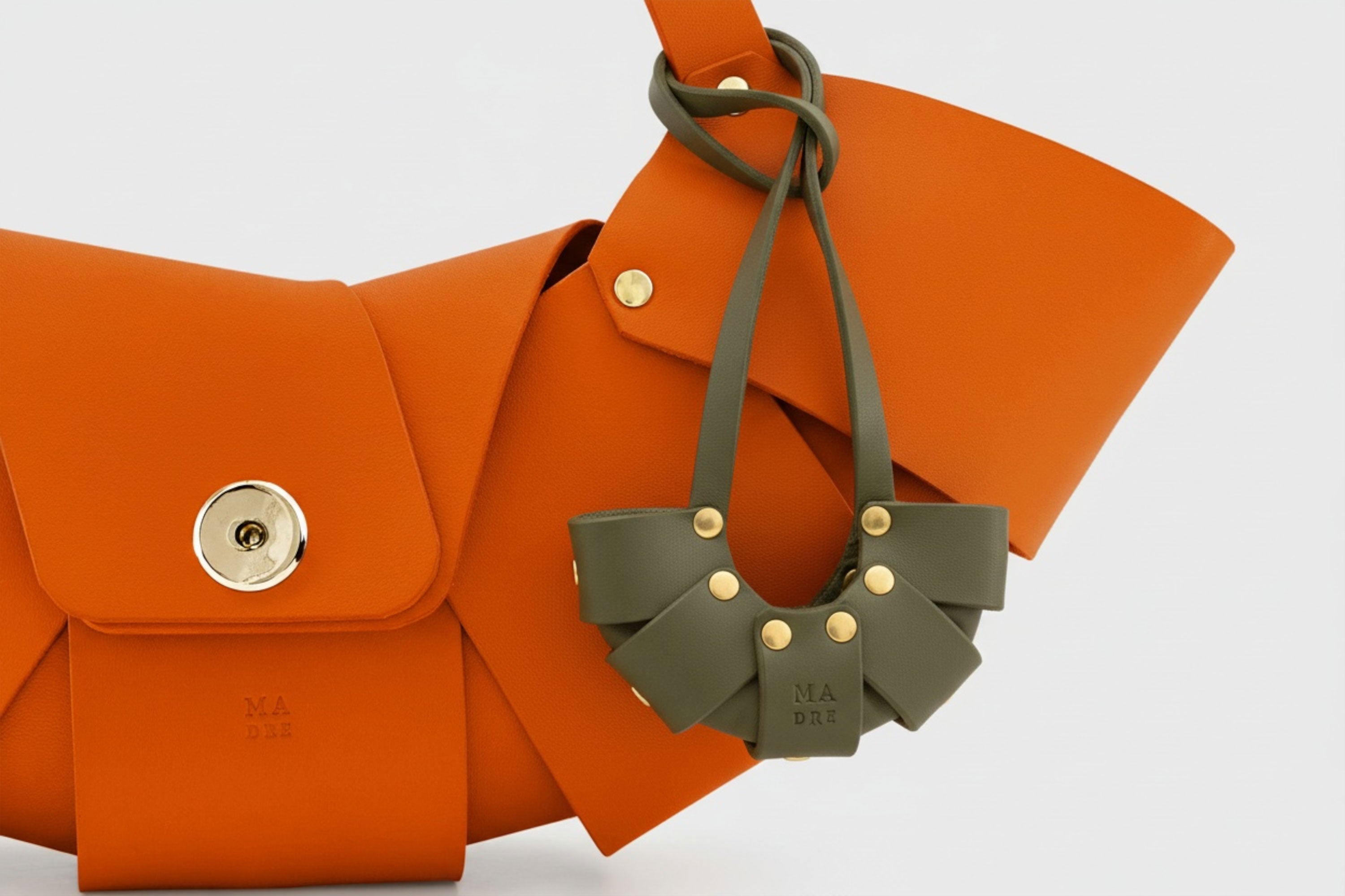 Olive Green Color Leather Croissant Bag Charm Minimal Premium Design Attached on Orange Croissant Bag Atelier Madre Manuel Dreesmann Barcelona Spain