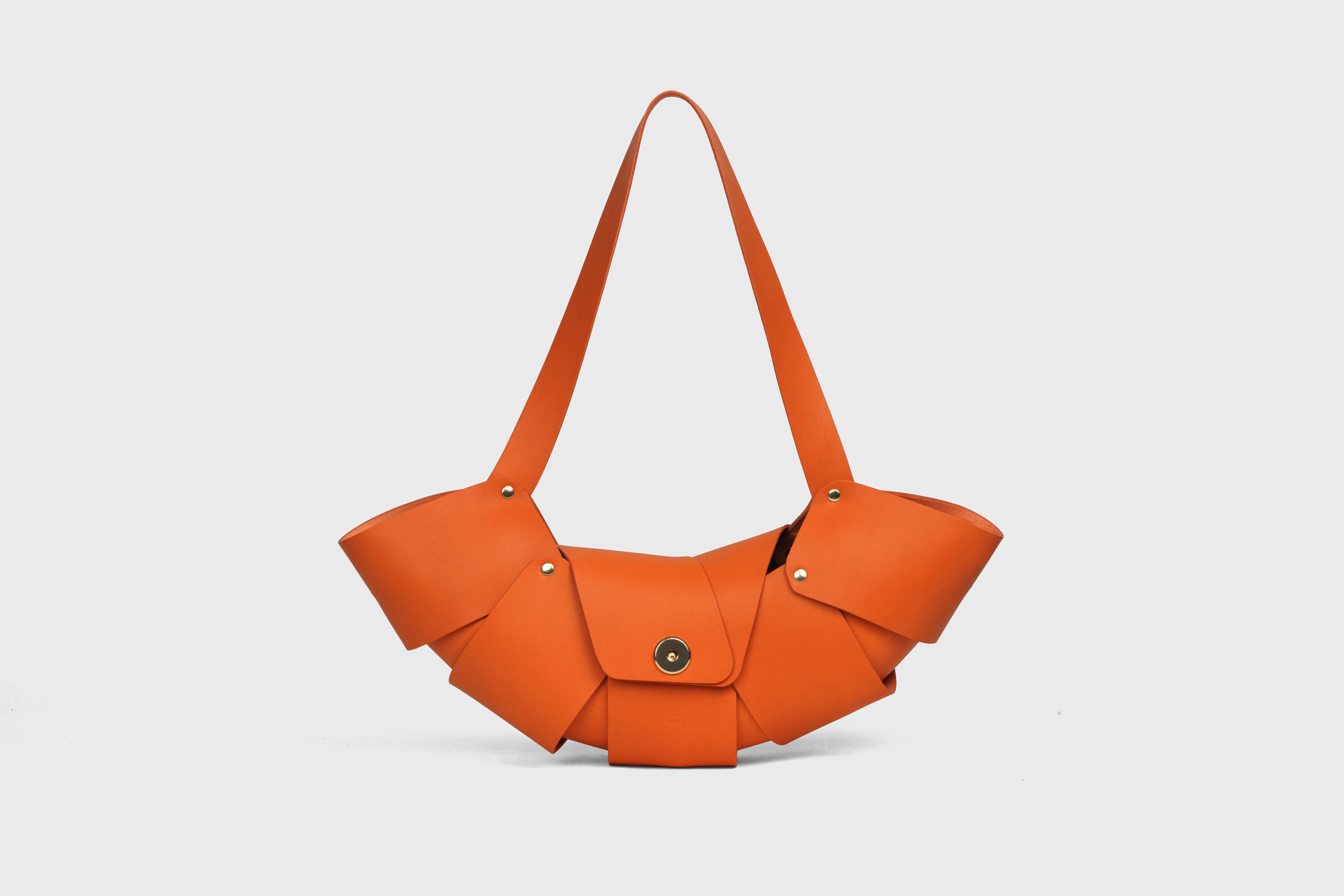 Croissant Bag Orange Leather Magnetic Closure Full Grain Vegetable Tanned Leather High Quality Modern Minimalistic Organic Design Full Brass Rivets Atelier Madre Manuel Dreesmann Barcelona Spain