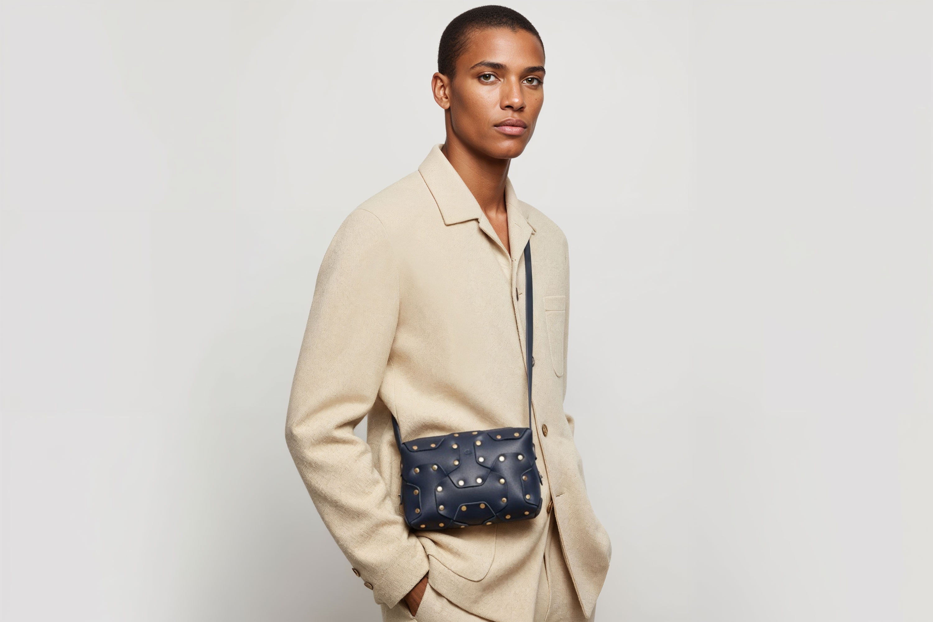 Double Rivet Bag Blue Color On A Man Model Leather Full Grain Vegetable Tanned Leather Modern Minimalist Design Premium Quality Full Brass Clutch Crossbody Shoulder Bag Atelier Madre Manuel Dreesmann Barcelona Spain