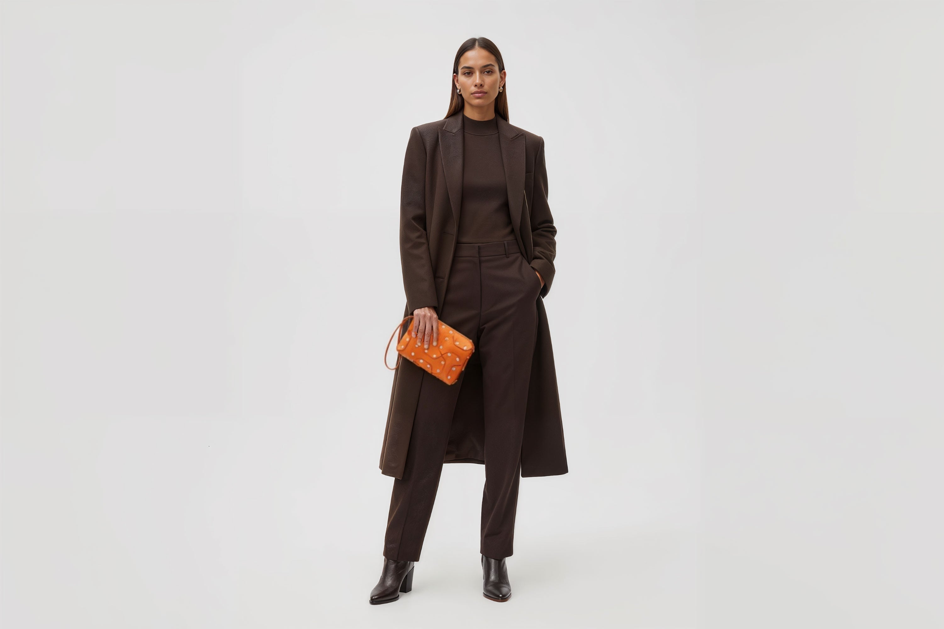 Double Rivet Bag Orange Color On A Woman Model Leather Full Grain Vegetable Tanned Leather Modern Minimalist Design Premium Quality Full Brass Clutch Crossbody Shoulder Bag Atelier Madre Manuel Dreesmann Barcelona Spain