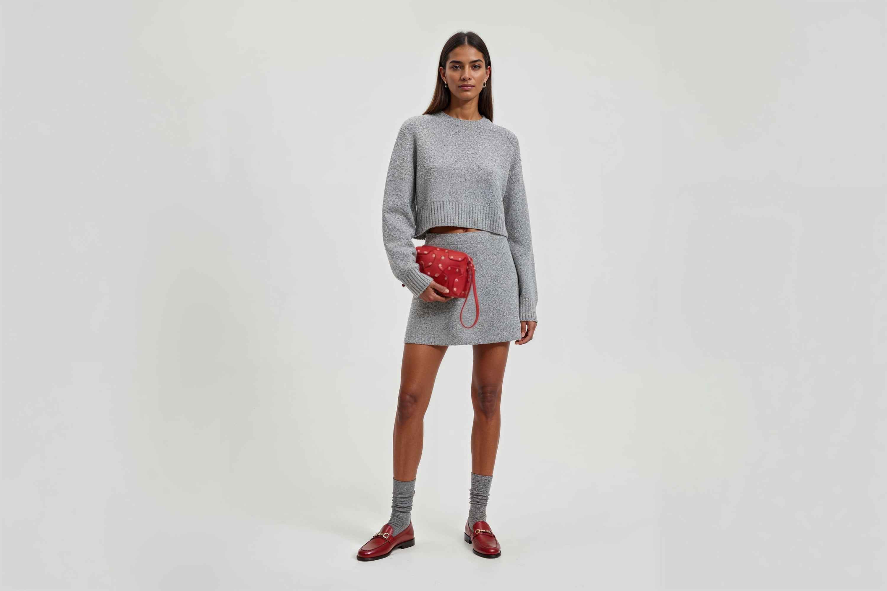 Double Rivet Bag Red Color On A Woman Model Leather Full Grain Vegetable Tanned Leather Modern Minimalist Design Premium Quality Full Brass Clutch Crossbody Shoulder Bag Atelier Madre Manuel Dreesmann Barcelona Spain