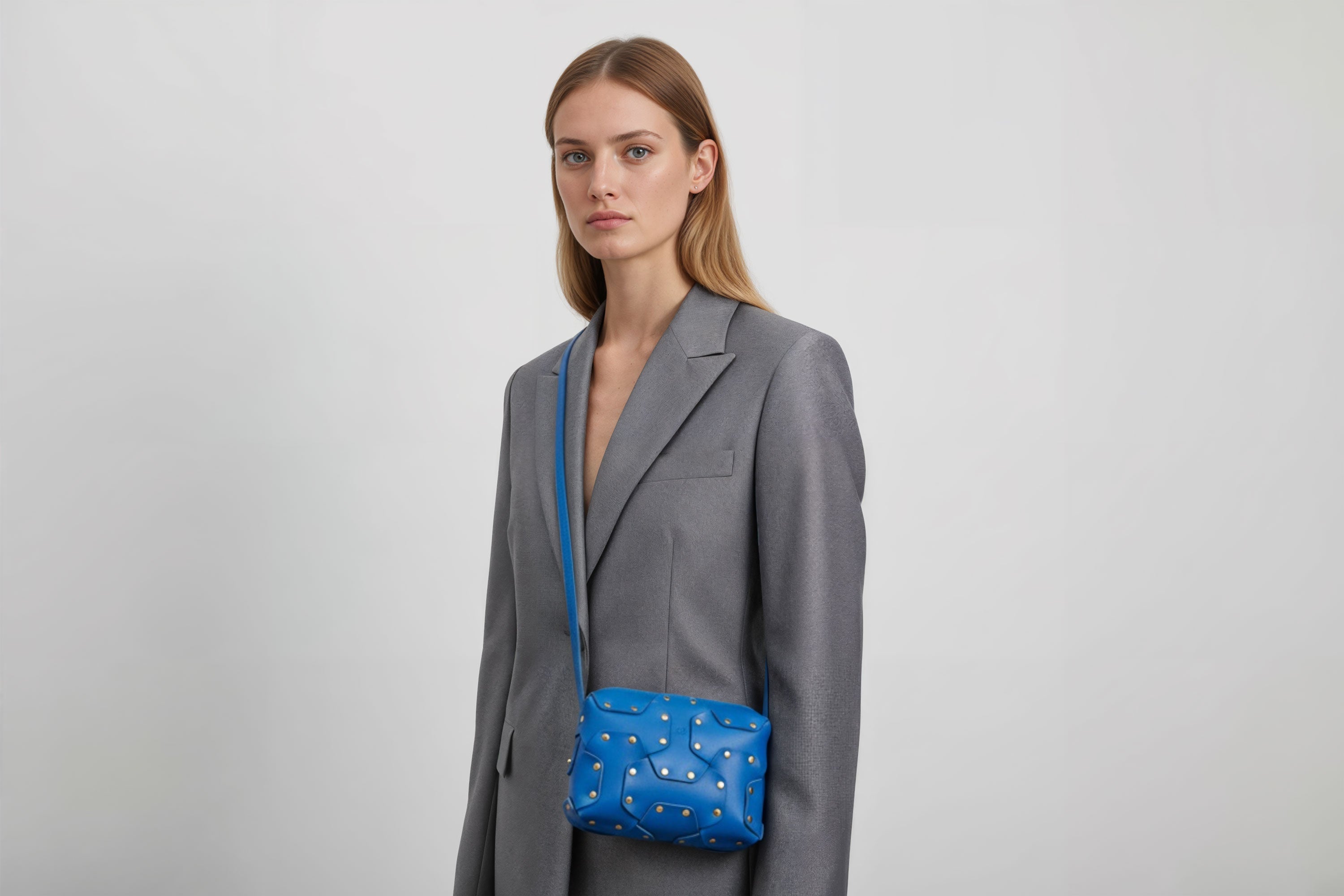 Double Rivet Bag Royal Blue Color On A Woman Model Leather Full Grain Vegetable Tanned Leather Modern Minimalist Design Premium Quality Full Brass Clutch Crossbody Shoulder Bag Atelier Madre Manuel Dreesmann Barcelona Spain