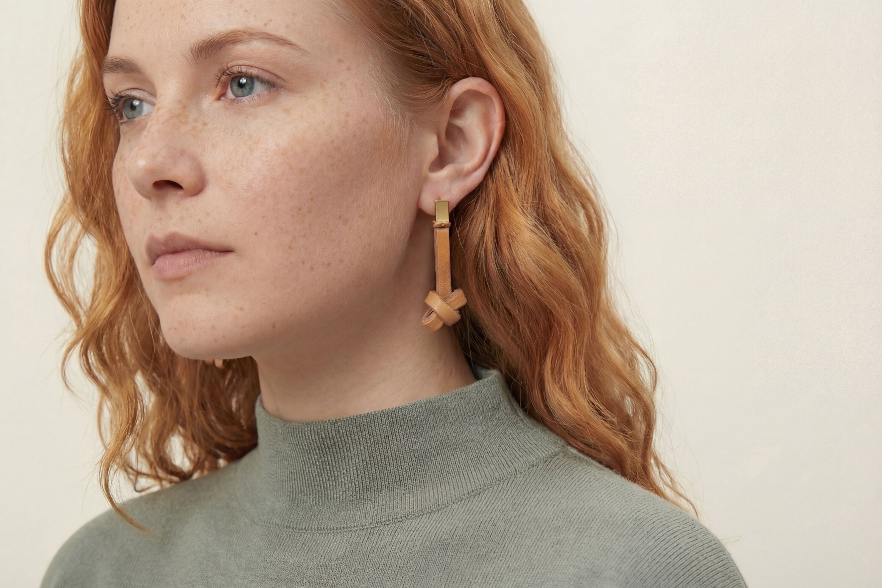 Gaia Earrings In Brown Color On Model In Vegetable Tanned Leather Minimalistic Design Atelier Madre Manuel Dreesmann Barcelona Spain