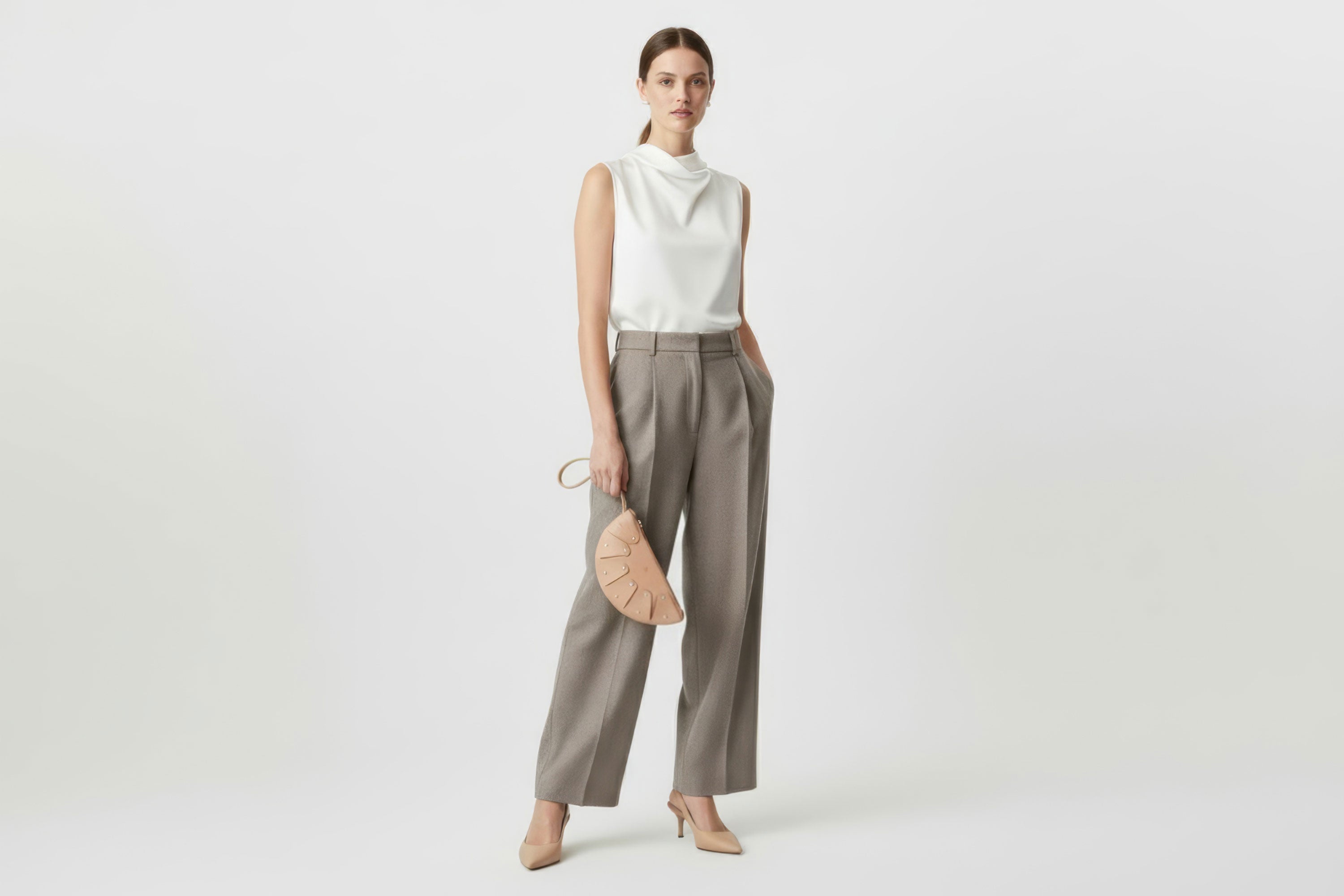 Juno Leather Bag Natural Color On A Model Vegetable Tanned Full Grain Spain Brass Rivets Design Minimalist Half Moon Circle Round Zipper Pouch Handbag Clutch Bag Atelier Madre Manuel Dreesmann Barcelona