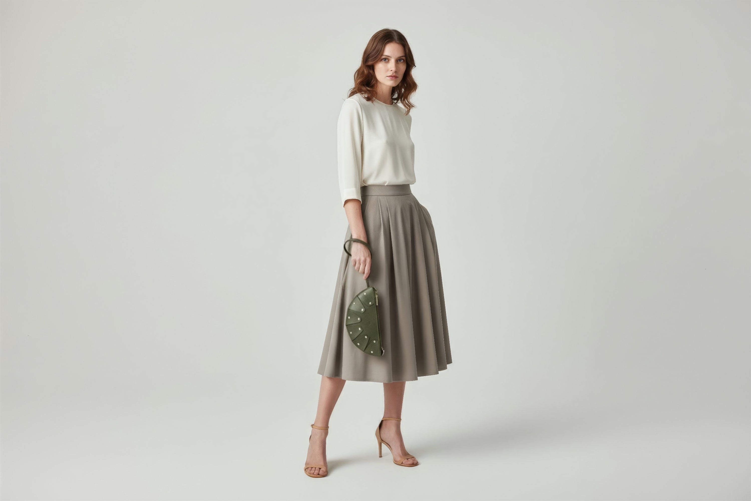 Juno Leather Bag Olive Green Color On A Model Vegetable Tanned Full Grain Spain Brass Rivets Design Minimalist Half Moon Circle Round Zipper Pouch Handbag Clutch Bag Atelier Madre Manuel Dreesmann Barcelona