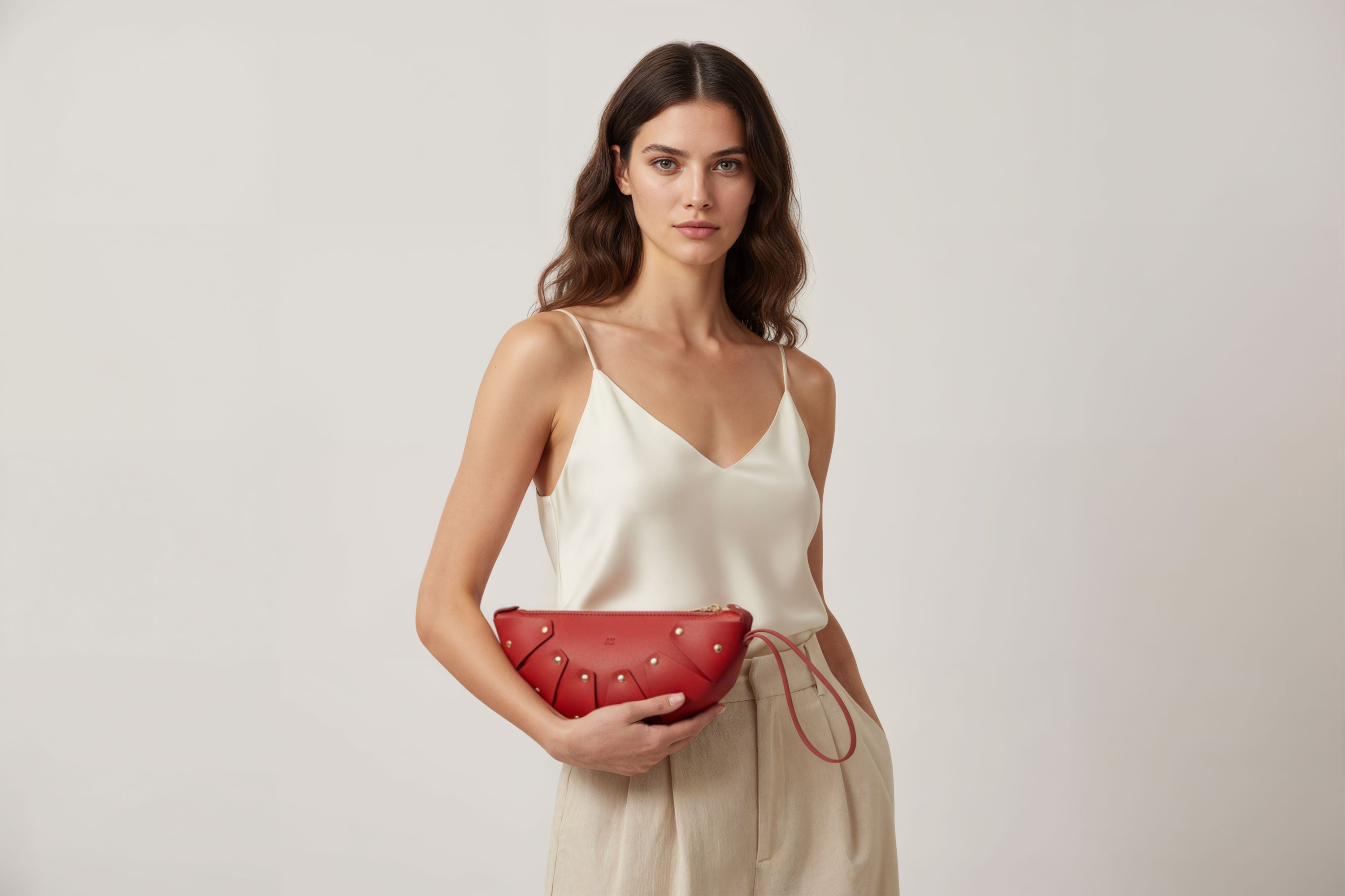 Juno Leather Bag Red Color On A Model Vegetable Tanned Full Grain Spain Brass Rivets Design Minimalist Half Moon Circle Round Zipper Pouch Handbag Clutch Bag Atelier Madre Manuel Dreesmann Barcelona