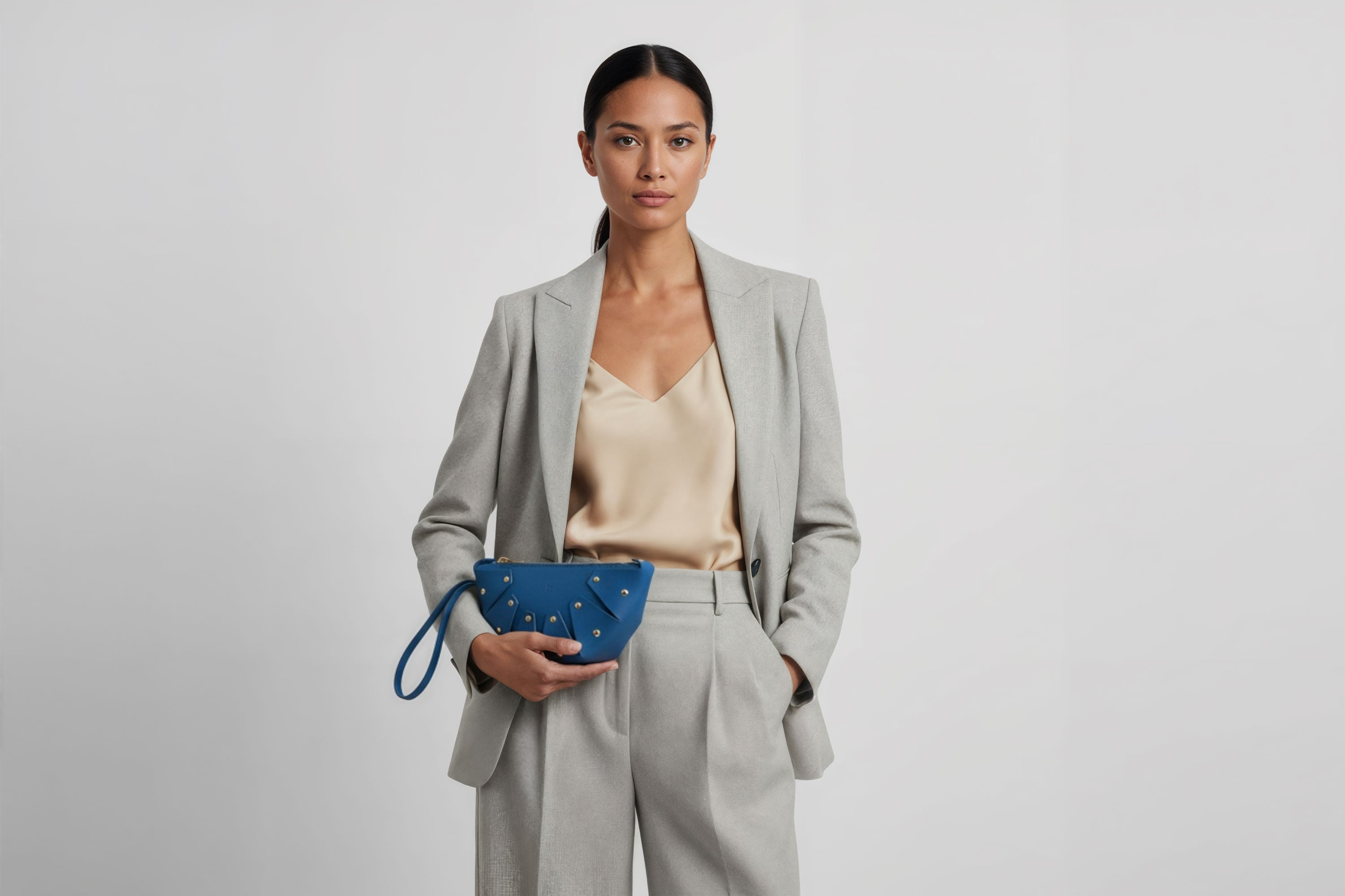 Juno Leather Bag Royal Blue Color On A Model Vegetable Tanned Full Grain Spain Brass Rivets Design Minimalist Half Moon Circle Round Zipper Pouch Handbag Clutch Bag Atelier Madre Manuel Dreesmann Barcelona