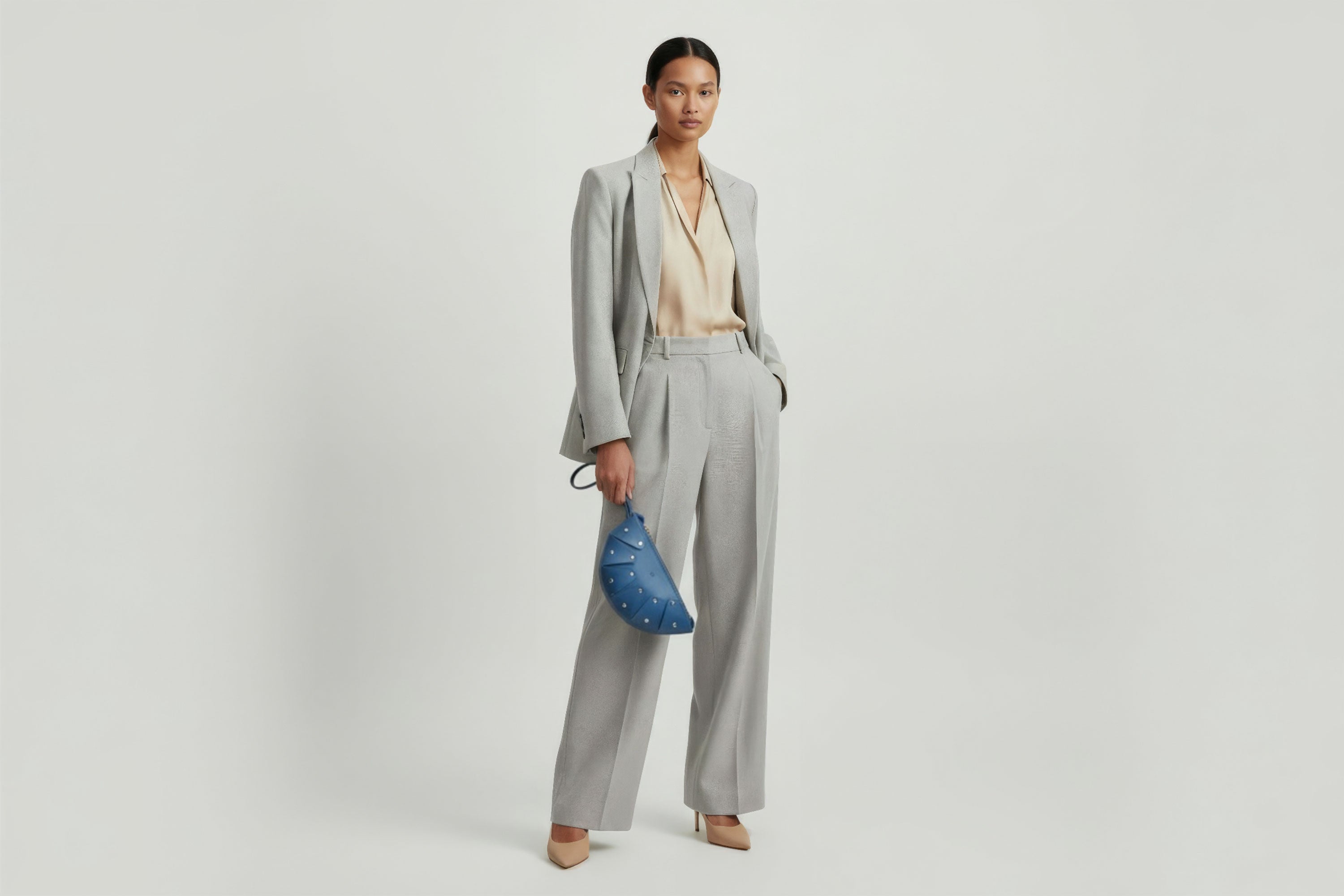 Juno Leather Bag Royal Blue Color On A Model Vegetable Tanned Full Grain Spain Brass Rivets Design Minimalist Half Moon Circle Round Zipper Pouch Handbag Clutch Bag Atelier Madre Manuel Dreesmann Barcelona