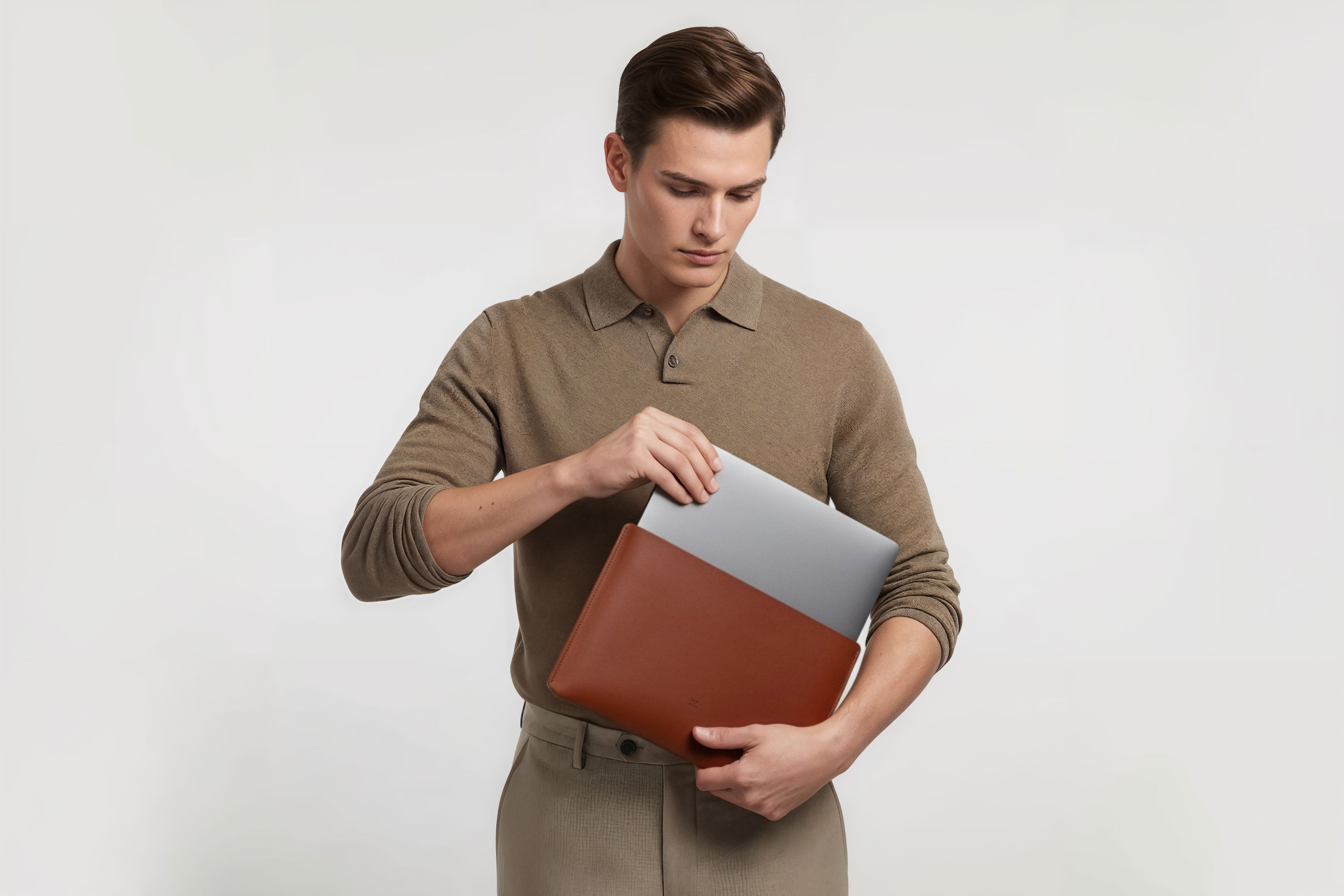 MacBook Slip Sleeve Dark Brown Leather Horizontal On Model Grey Background Minimalistic Premium Design Atelier Madre Manuel Dreesmann Barcelona