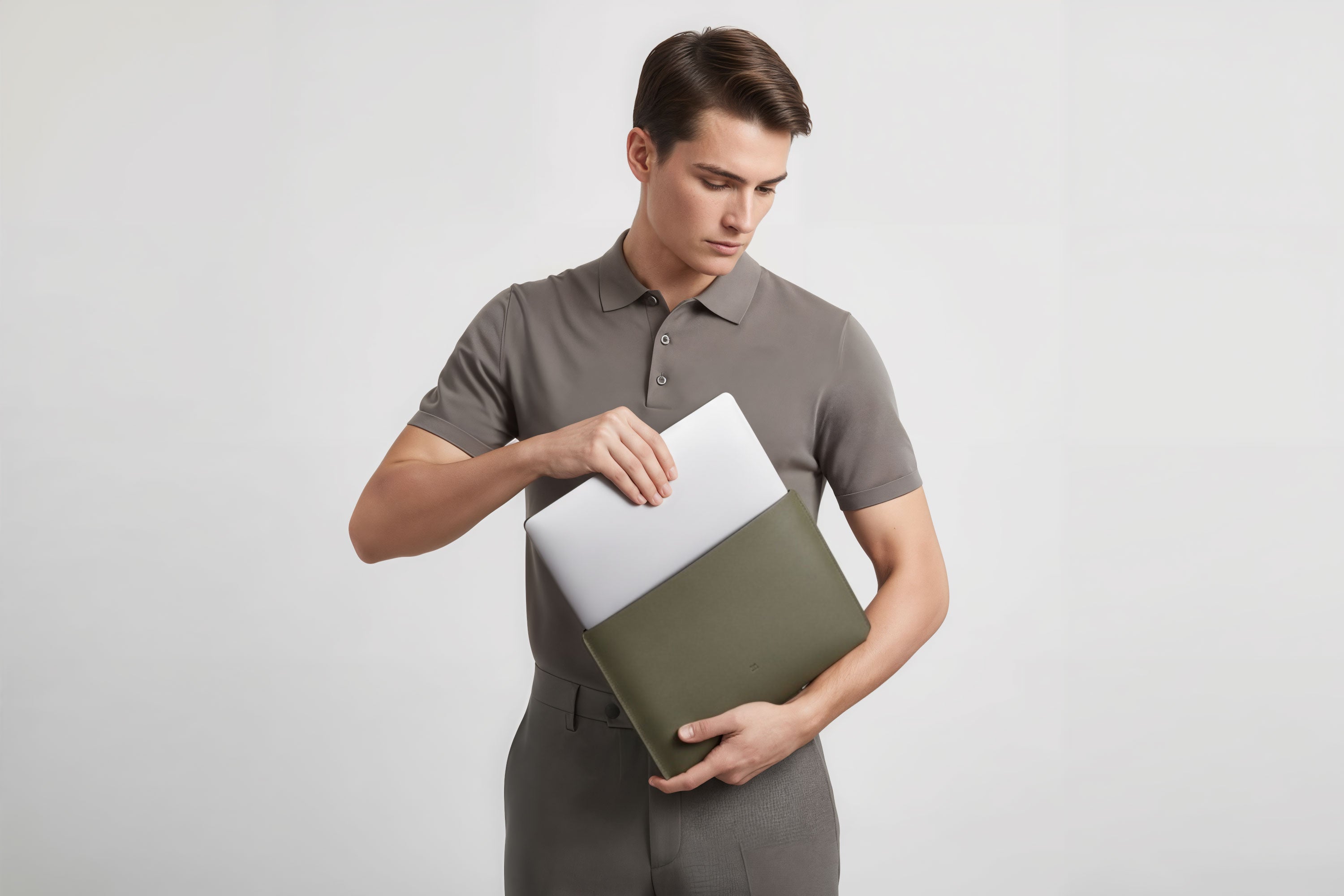 MacBook Slip Sleeve Olive Green Horizontal On Model Grey Background Minimalistic Premium Design Atelier Madre Manuel Dreesmann Barcelona