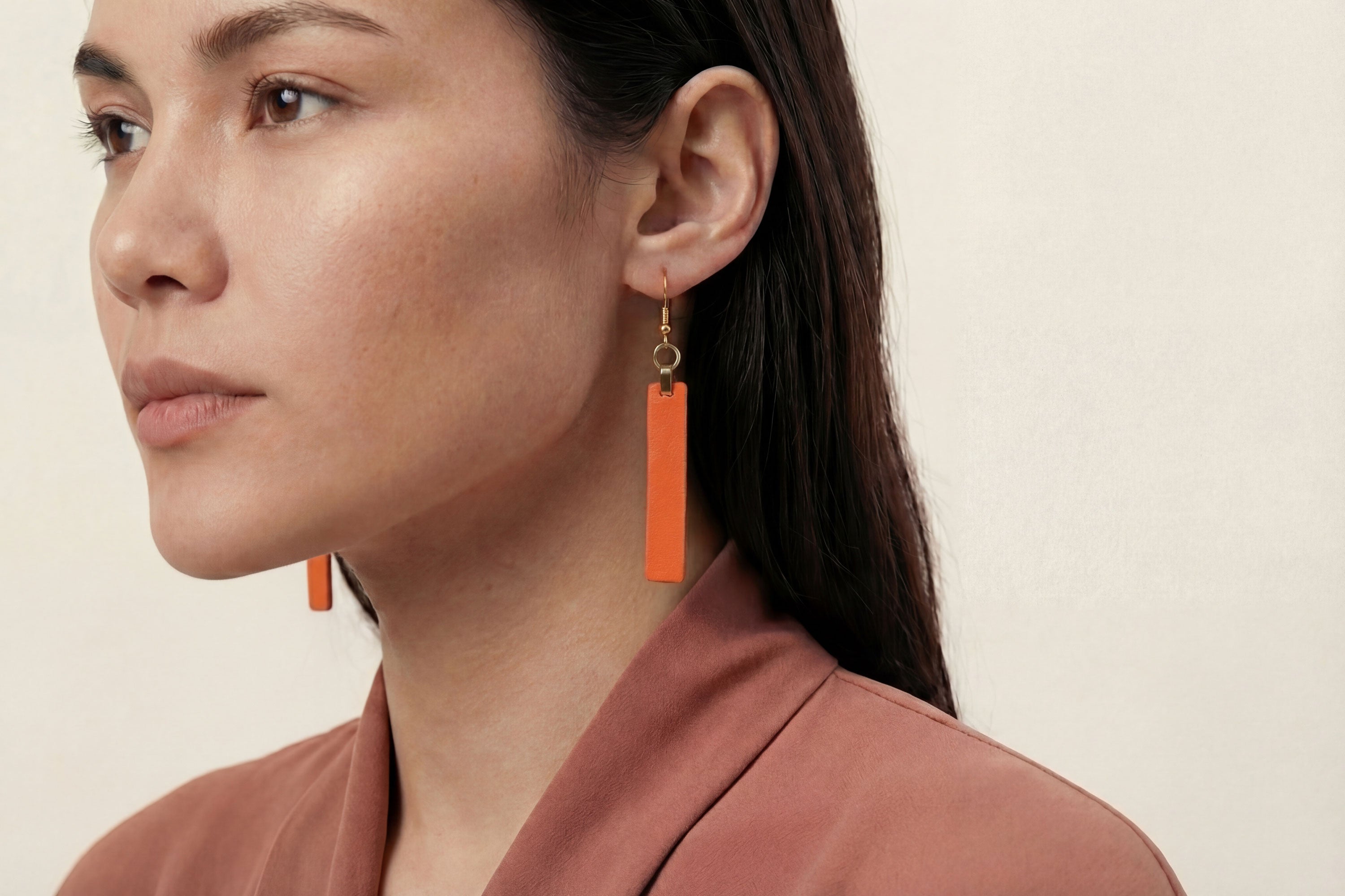 Lia Earrings Leather In Orange Color On Model Vegetable Tanned Leather Atelier Madre Manuel Dreesmann Barcelona Spain