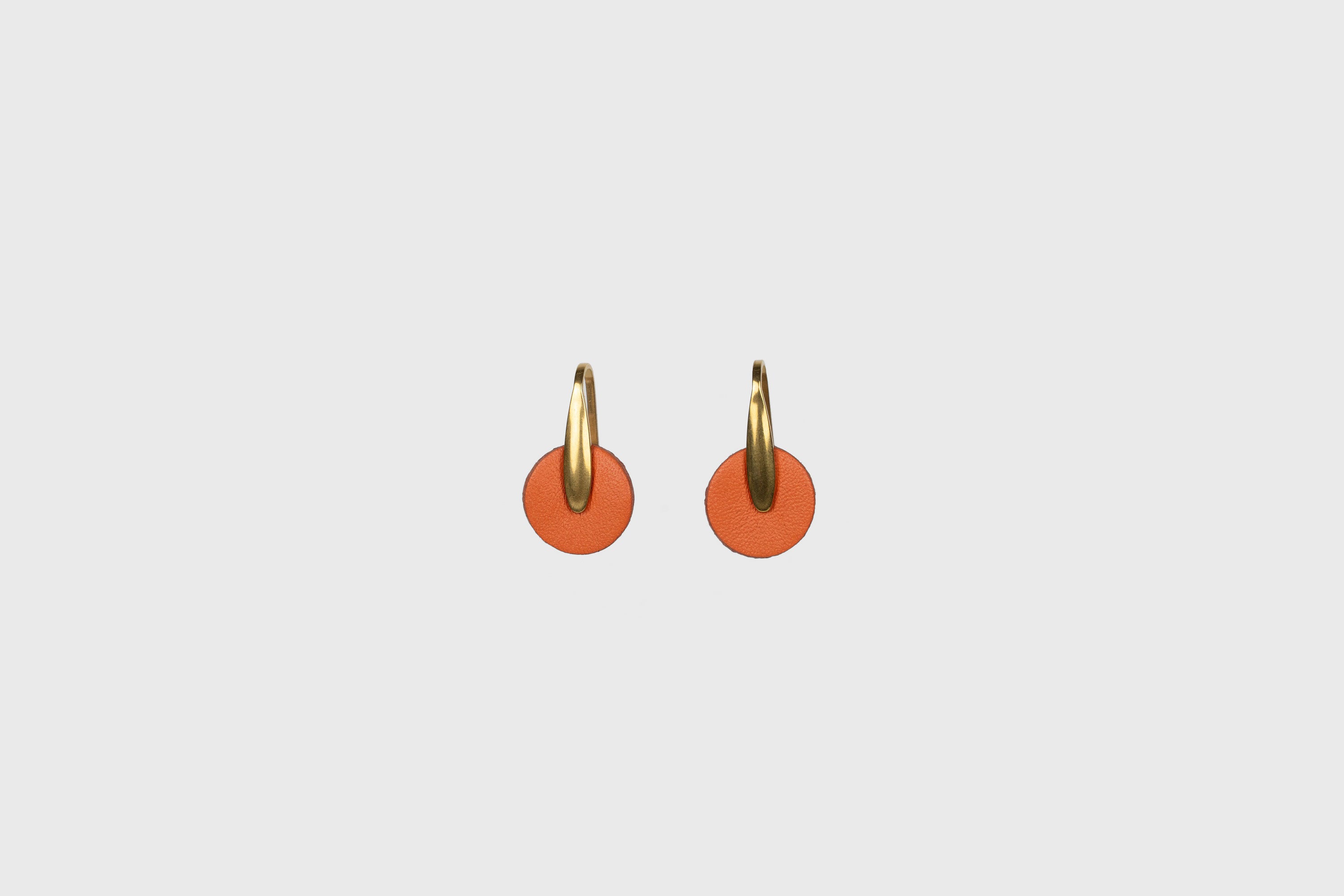 Lina Earrings In Orange Color In Vegetable Tanned Leather Brass Hook Minimalistic Design Atelier Madre Manuel Dreesmann Barcelona Spain