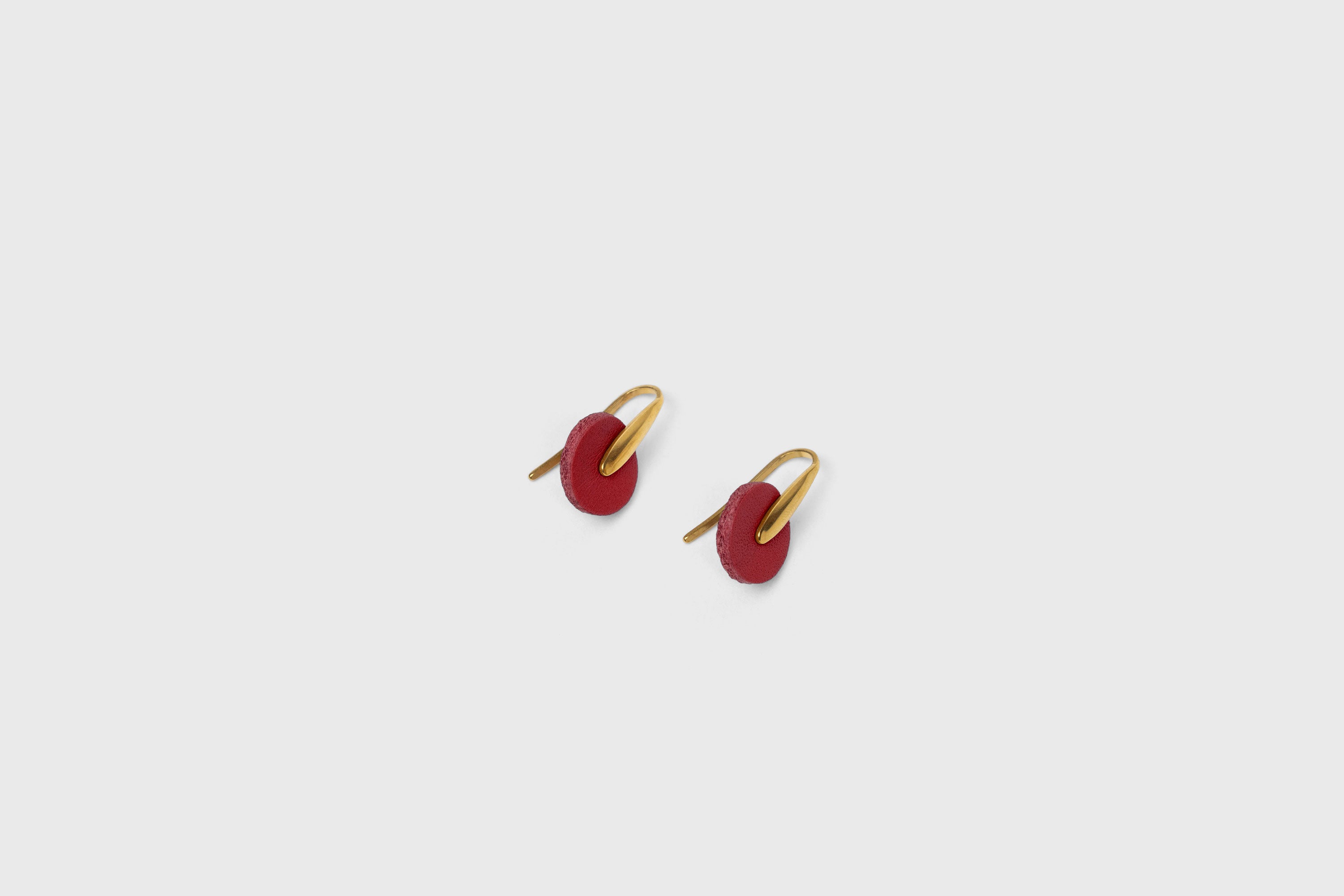 Lina Earrings In Red Color In Vegetable Tanned Leather Brass Hook Minimalistic Design Atelier Madre Manuel Dreesmann Barcelona Spain