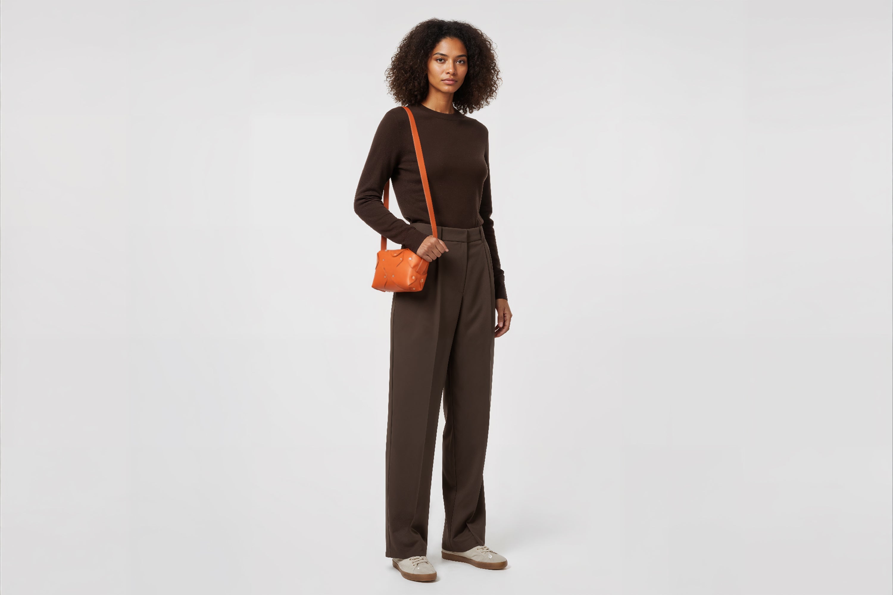 Marlin Leather Bag Small Orange Color On A Woman Model Premium Quality Minimalist Design Atelier Madre Manuel Dreesmann Barcelona Spain