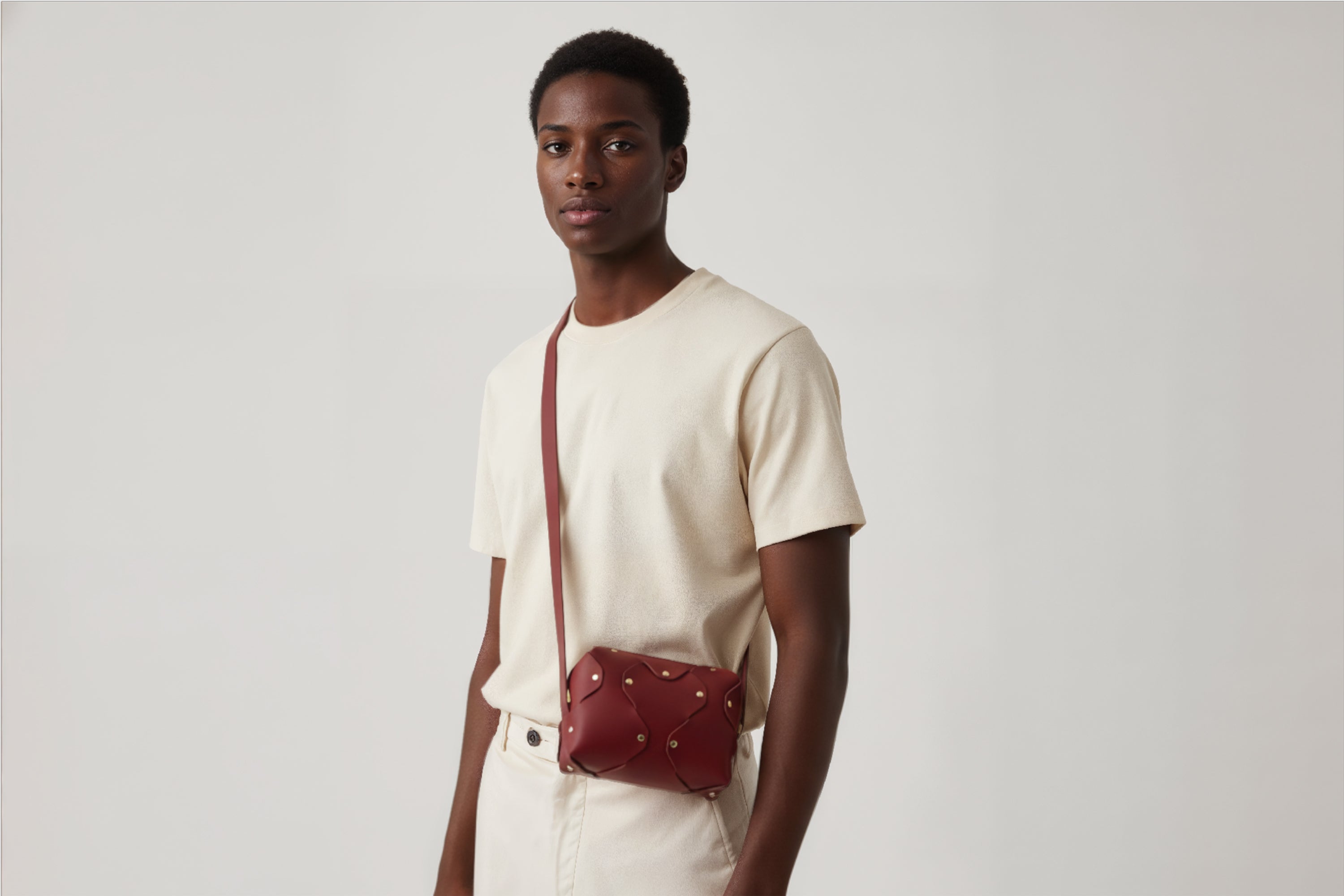 Marlin Leather Bag Small Red Color On A Man Model Premium Quality Minimalist Design Atelier Madre Manuel Dreesmann Barcelona Spain