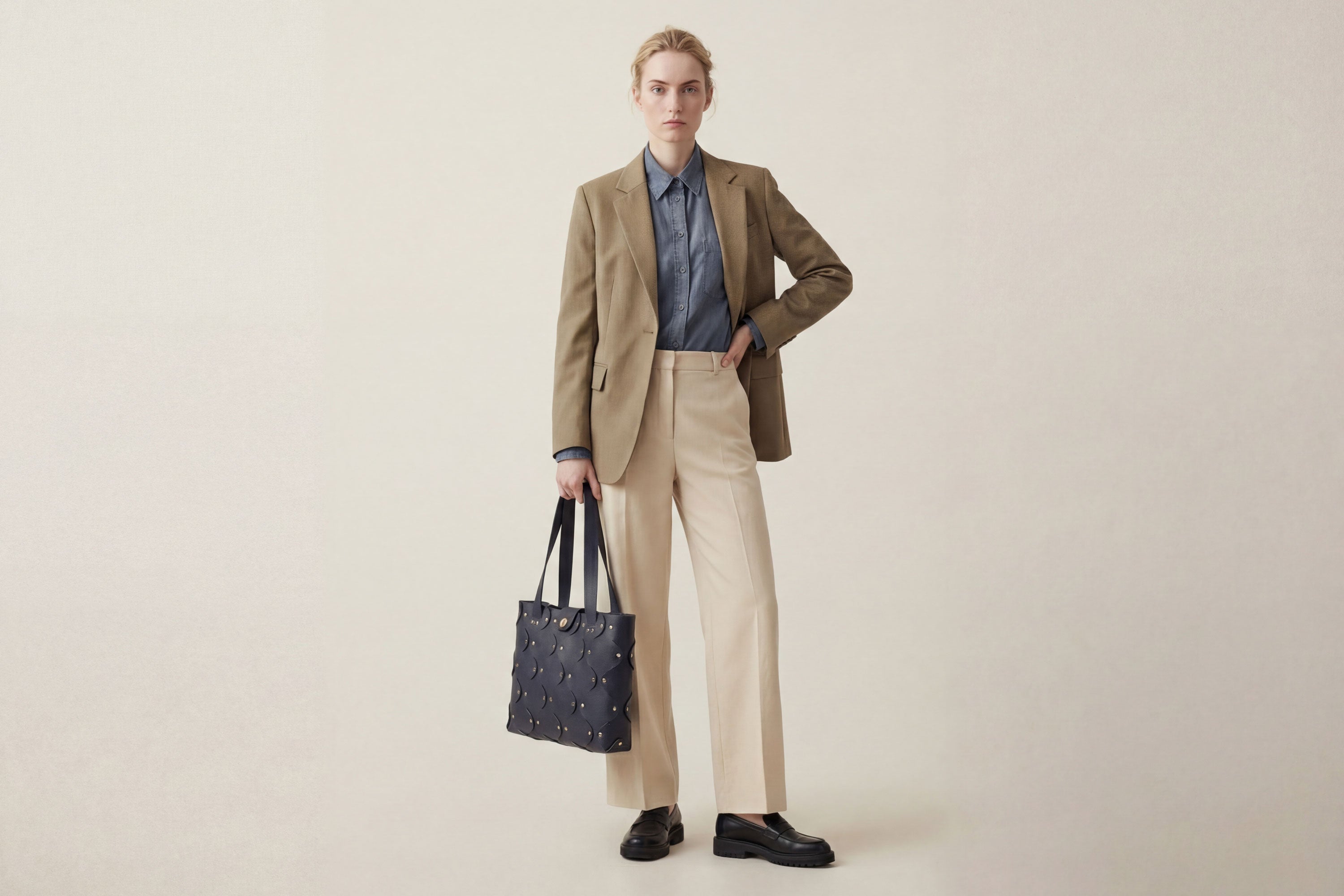 Marlin Tote Bag In Marine Blue Color On Model In Vegetable Tanned Leather With Rivets Atelier Madre Manuel Dreesmann Barcelona Spain