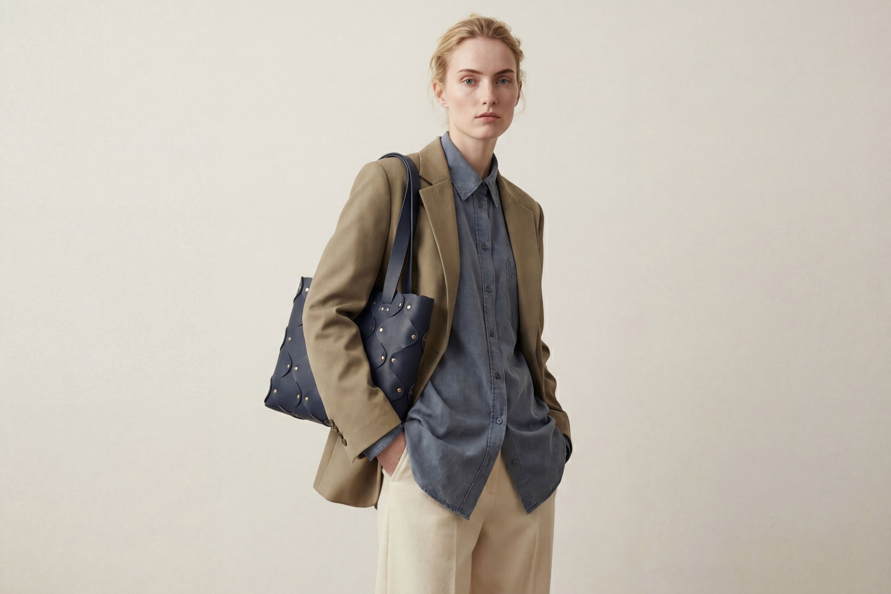 Marlin Tote Bag In Marine Blue Color On Model In Vegetable Tanned Leather With Rivets Atelier Madre Manuel Dreesmann Barcelona Spain