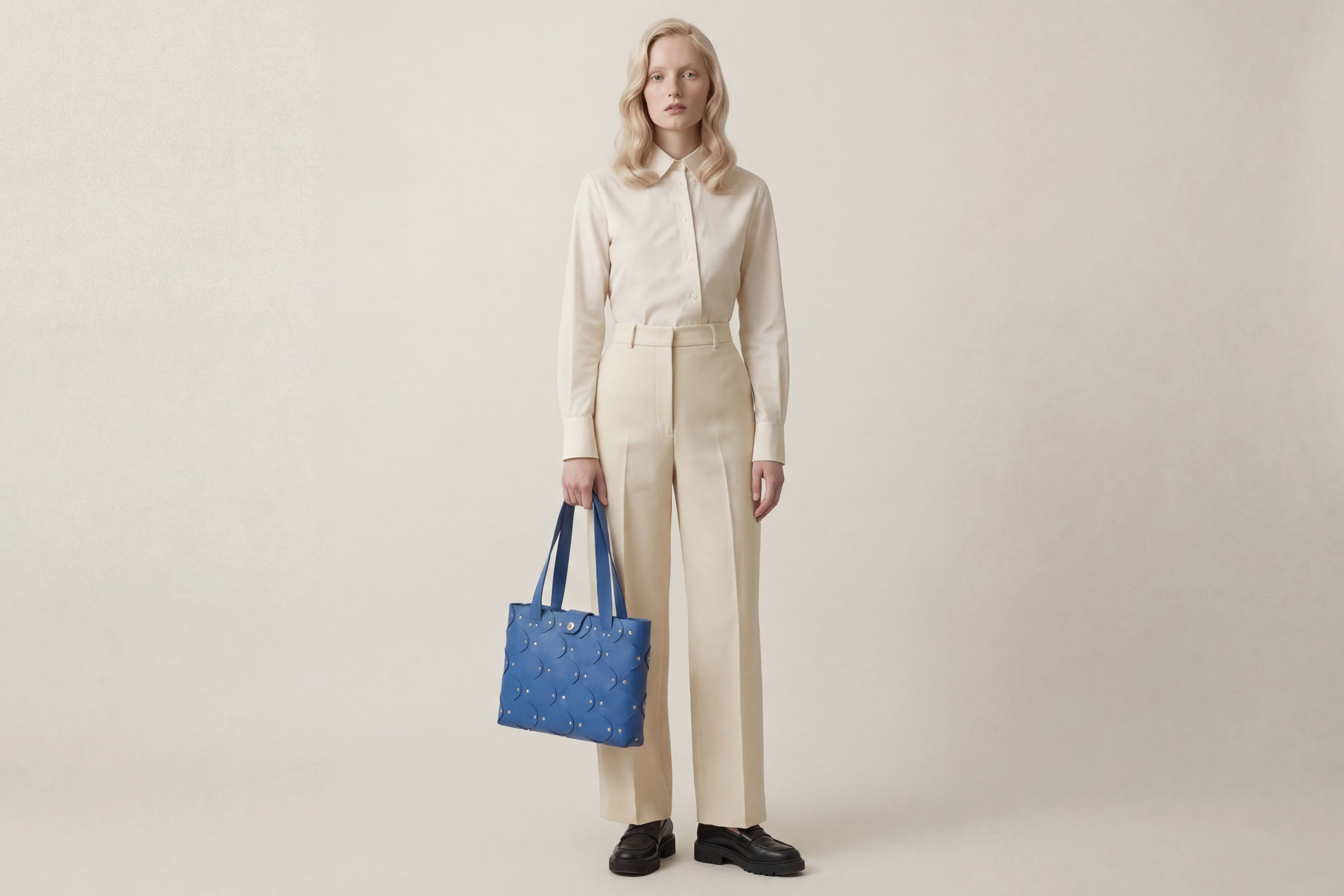 Marlin Tote Bag In Royal Blue Color On Model In Vegetable Tanned Leather With Rivets Atelier Madre Manuel Dreesmann Barcelona Spain