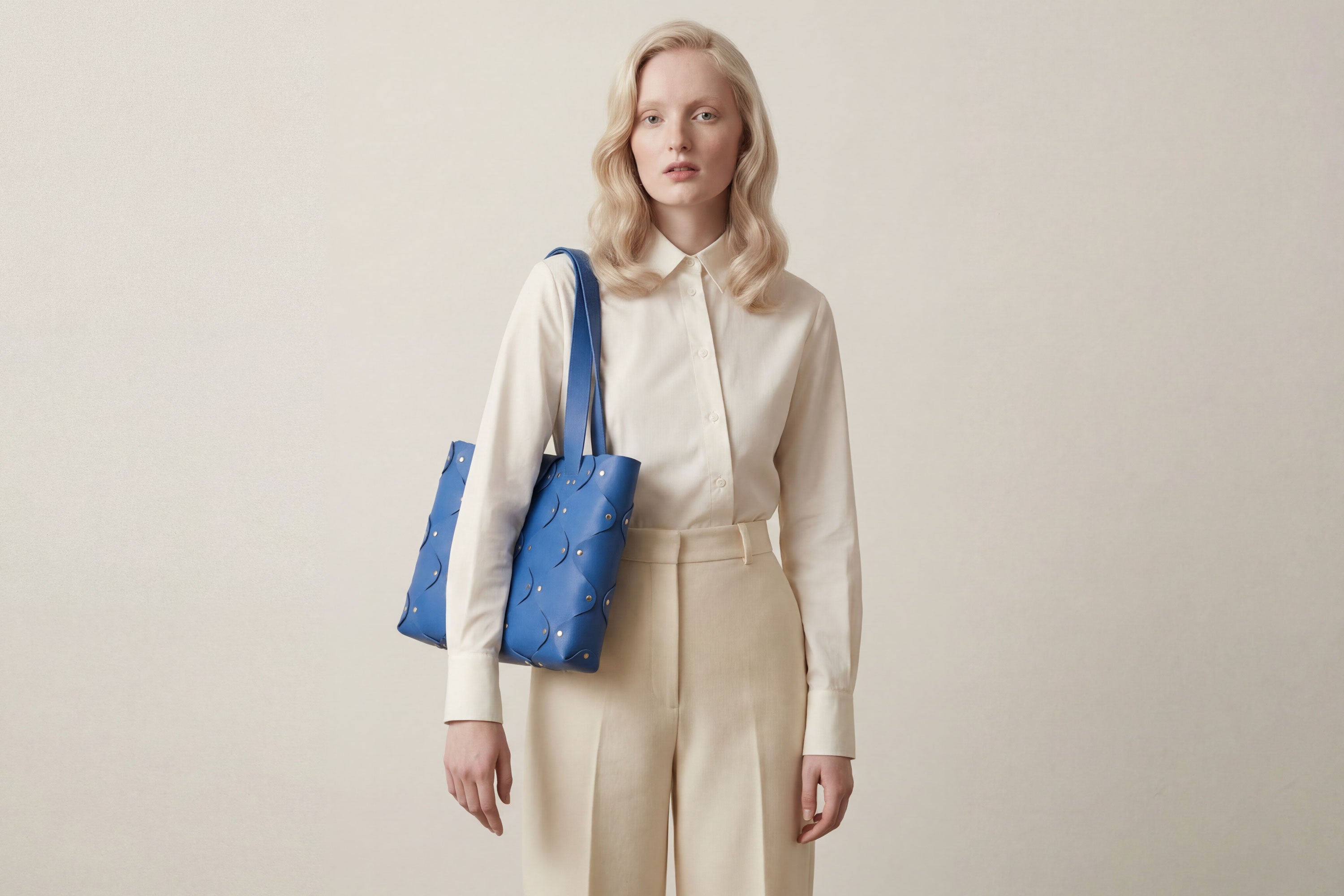 Marlin Tote Bag In Royal Blue Color On Model In Vegetable Tanned Leather With Rivets Atelier Madre Manuel Dreesmann Barcelona Spain