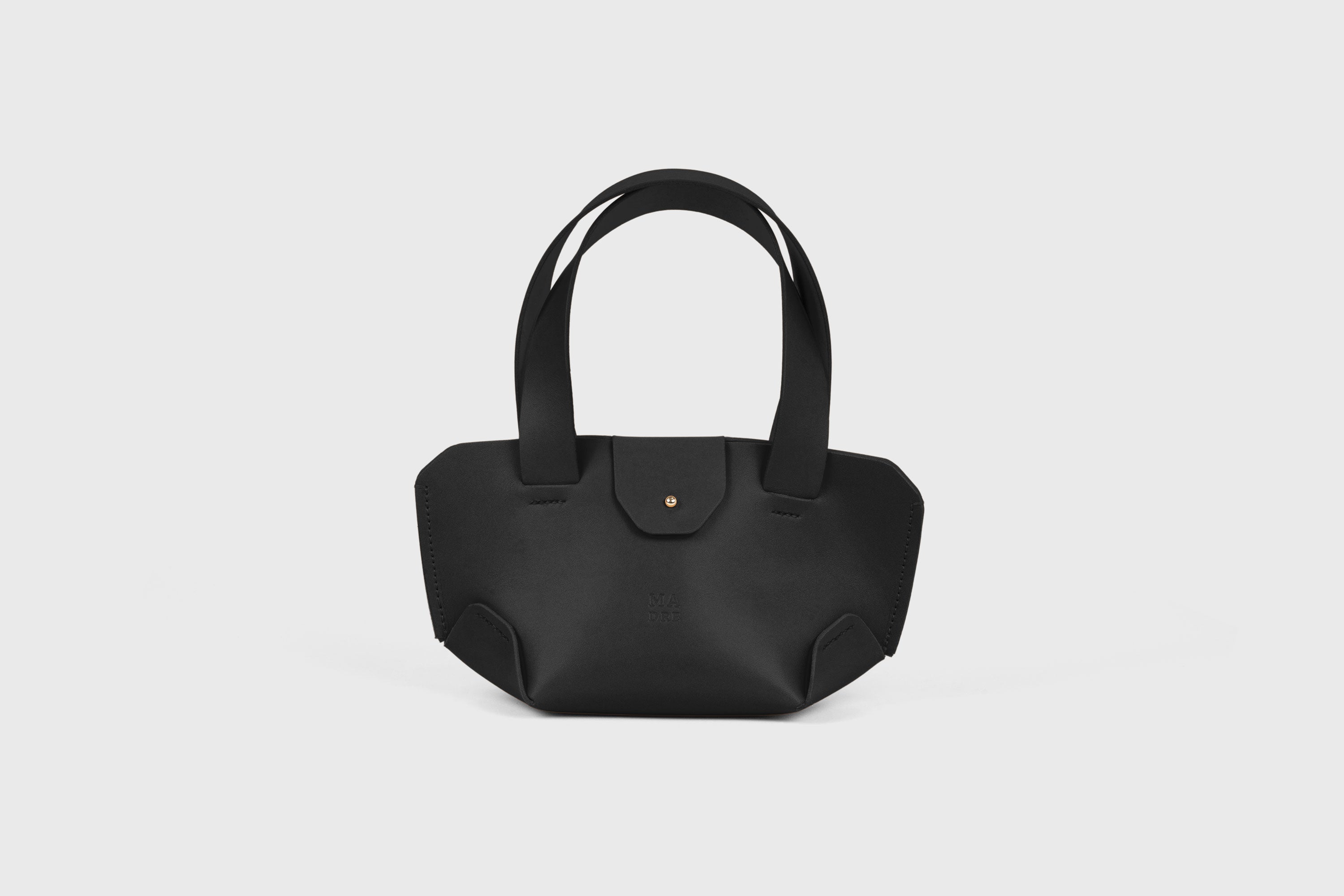 Mini Tote Bag In Black Color In Vegetable Tanned Leather Bag With A Flap In Minimalistic Design Atelier Madre Manuel Dreesmann