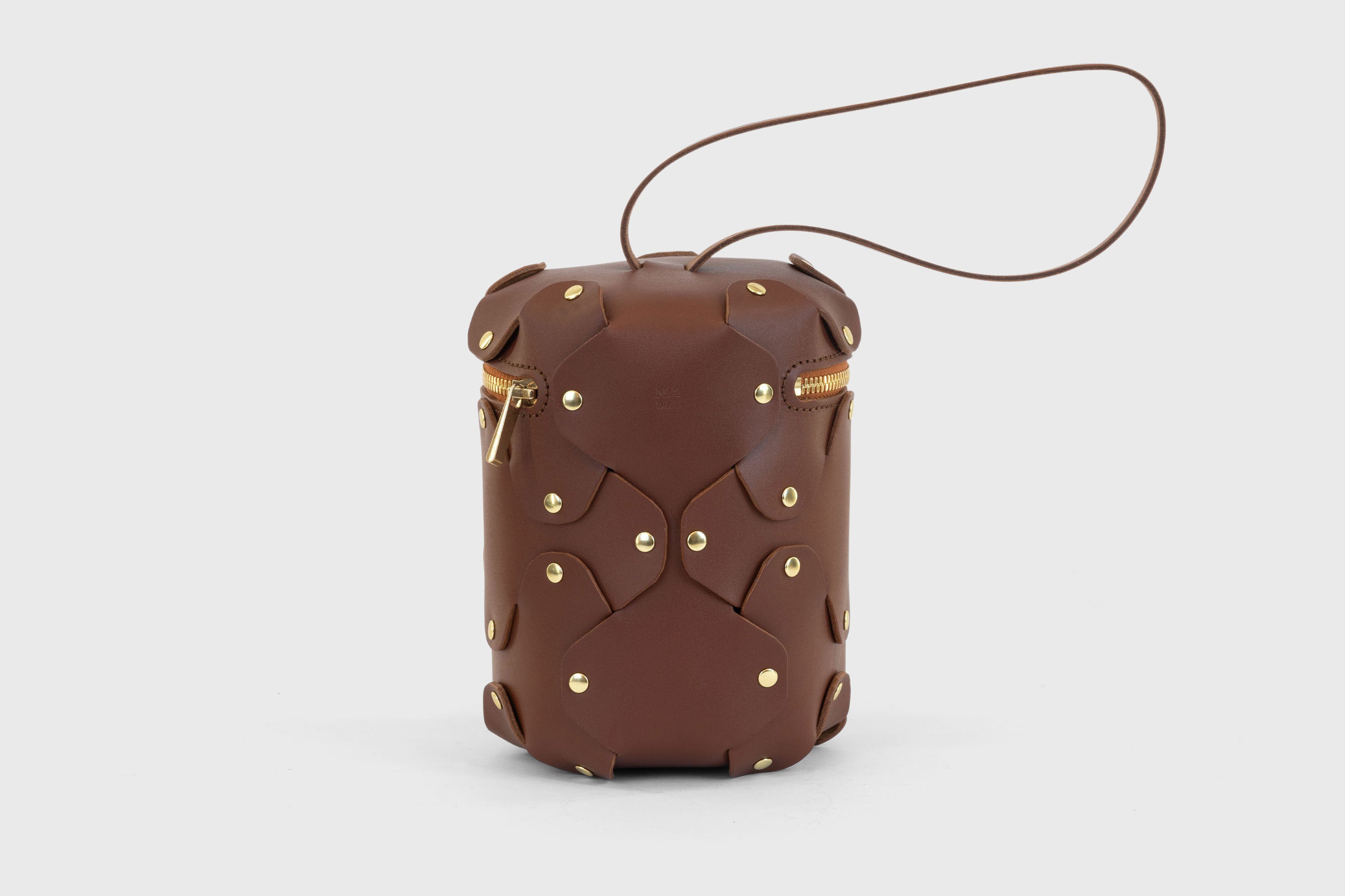 Nema Leather Bag Dark Brown Color Vegetable Tanned Full Grain Spain Brass Rivets Premium Design Minimalist Modern Cylinder Circle Round Zipper Pouch Handbag Clutch Bag Atelier Madre Manuel Dreesmann Barcelona