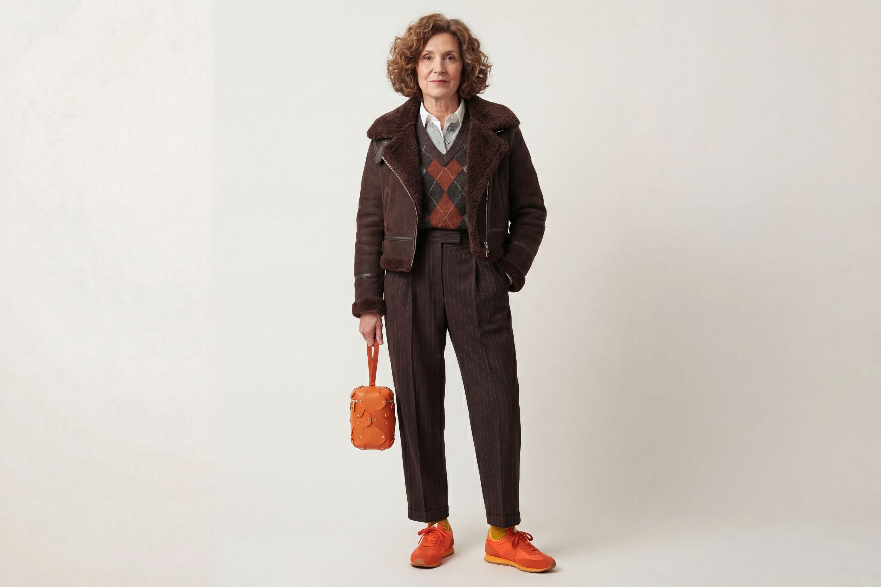 Nema Leather Bag Orange Color On A Woman Model Vegetable Tanned Full Grain Spain Brass Rivets Premium Design Minimalist Modern Cylinder Circle Round Zipper Pouch Handbag Atelier Madre Manuel Dreesmann Barcelona