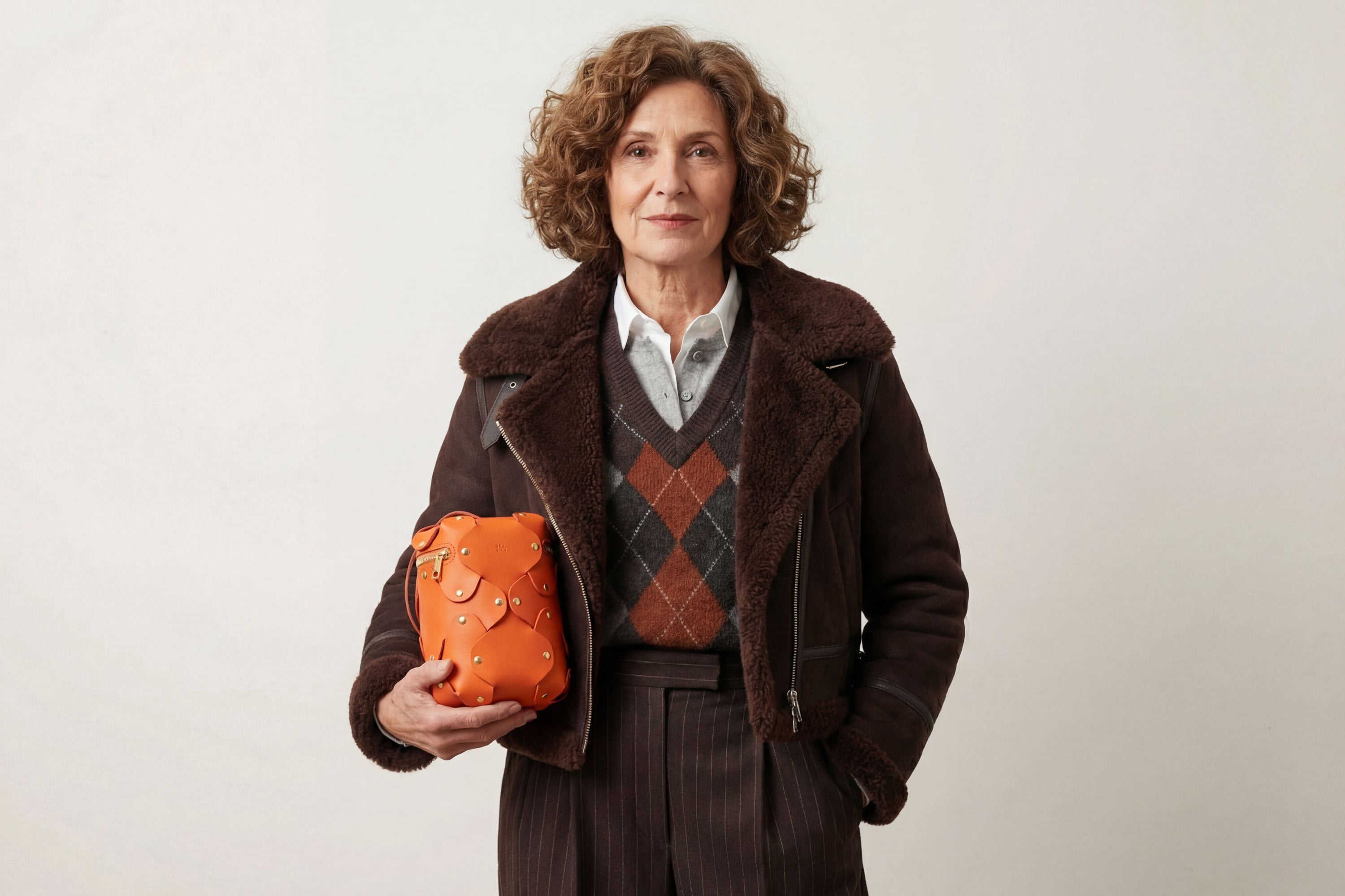 Nema Leather Bag Orange Color On A Woman Model Vegetable Tanned Full Grain Spain Brass Rivets Premium Design Minimalist Modern Cylinder Circle Round Zipper Pouch Handbag Atelier Madre Manuel Dreesmann Barcelona