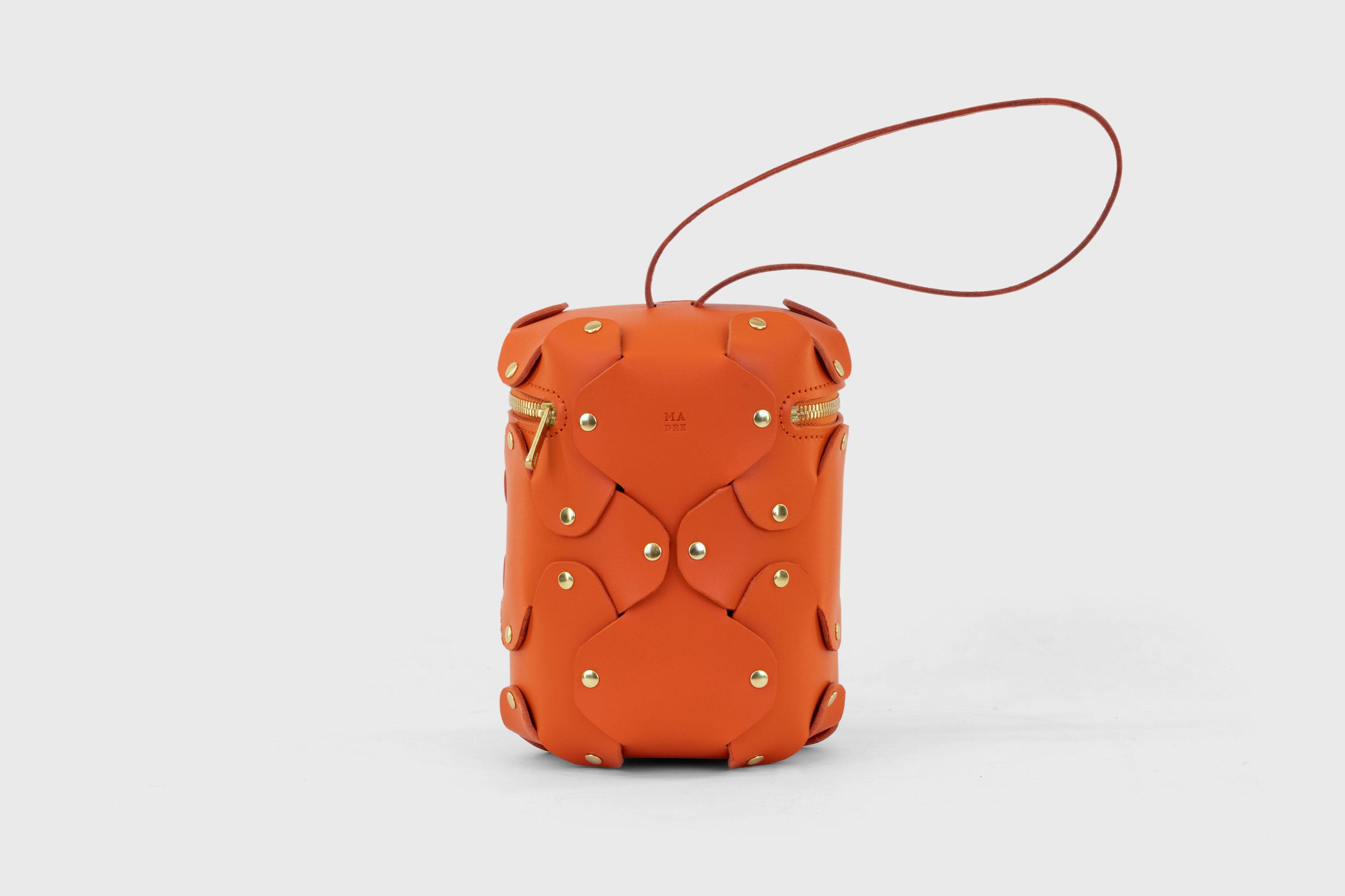 Nema Leather Bag Orange Color Vegetable Tanned Full Grain Spain Brass Rivets Premium Design Minimalist Modern Cylinder Circle Round Zipper Pouch Handbag Clutch Bag Atelier Madre Manuel Dreesmann Barcelona