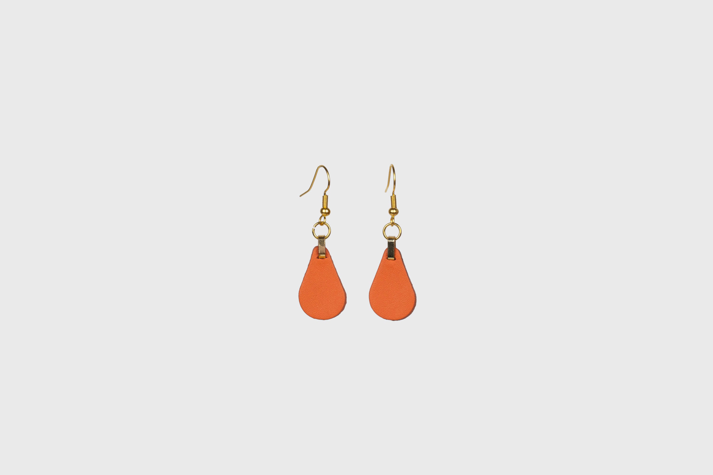 Ona Earrings In Orange Color In Vegetable Tanned Leather Minimalistic Design Atelier Madre Manuel Dreesmann Barcelona Spain