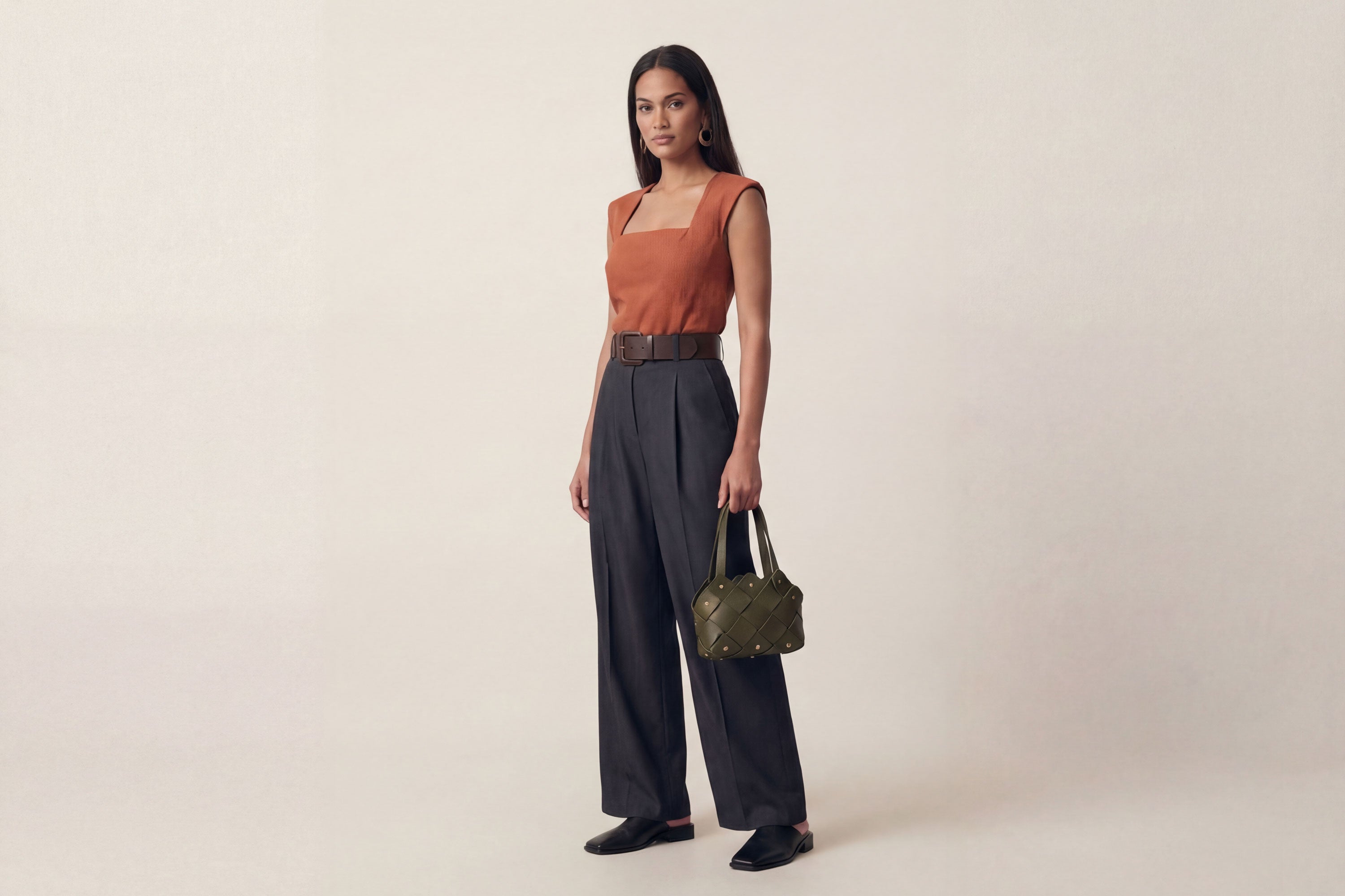 Pine Mini Tote Bag In Olive Green Color In Vegetable Tanned Leather On Woman Model Woven Technique and Brass Rivets Atelier Madre Manuel Dreesmann Barcelona Spain