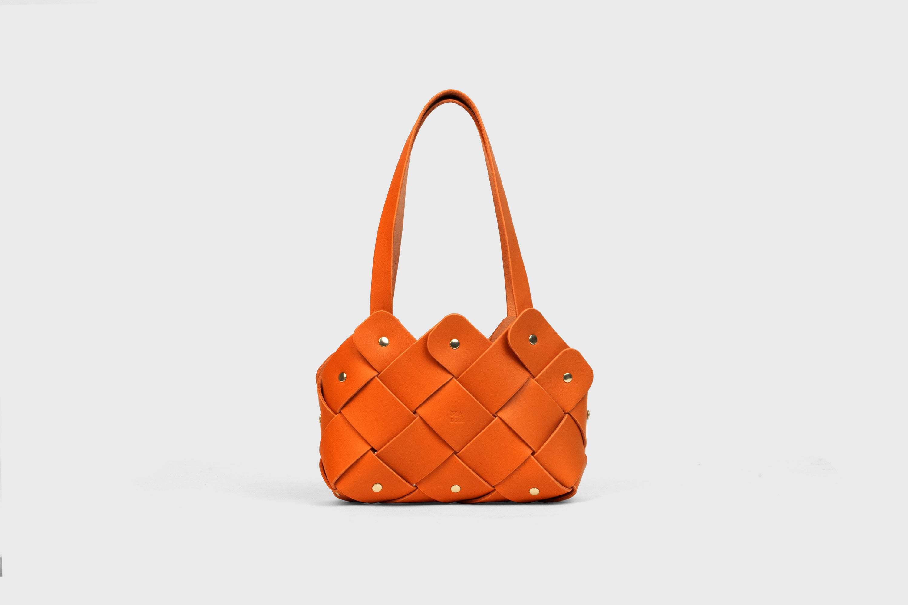 Pine Mini Tote Bag In Orange Color In Vegetable Tanned Leather Woven Technique and Brass Rivets Atelier Madre Manuel Dreesmann Barcelona Spain