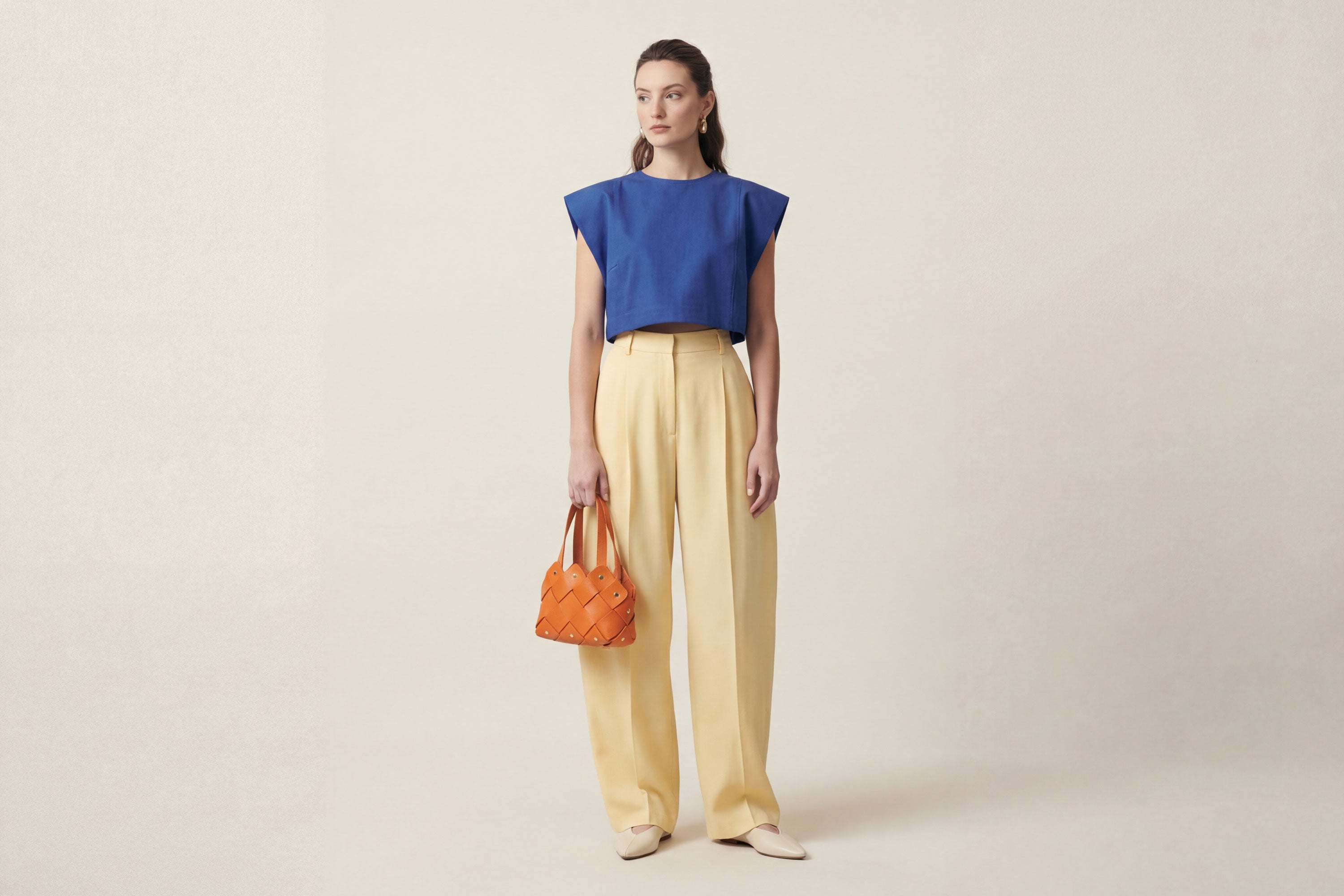 Pine Mini Tote Bag In Orange Color In Vegetable Tanned Leather On Woman Model Woven Technique and Brass Rivets Atelier Madre Manuel Dreesmann Barcelona Spain