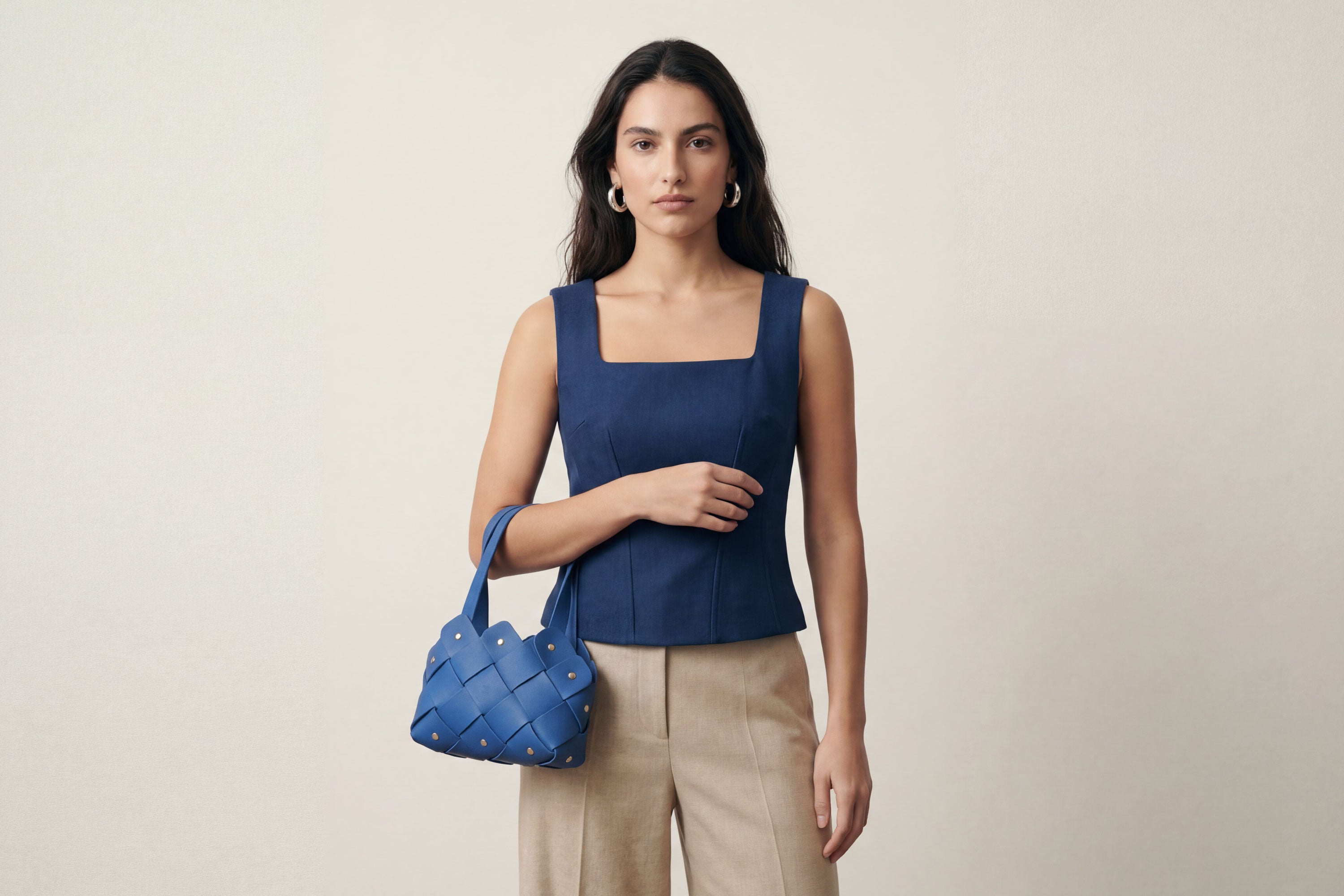 Pine Mini Tote Bag In Royal Blue Color In Vegetable Tanned Leather On Woman Model Woven Technique and Brass Rivets Atelier Madre Manuel Dreesmann Barcelona Spain