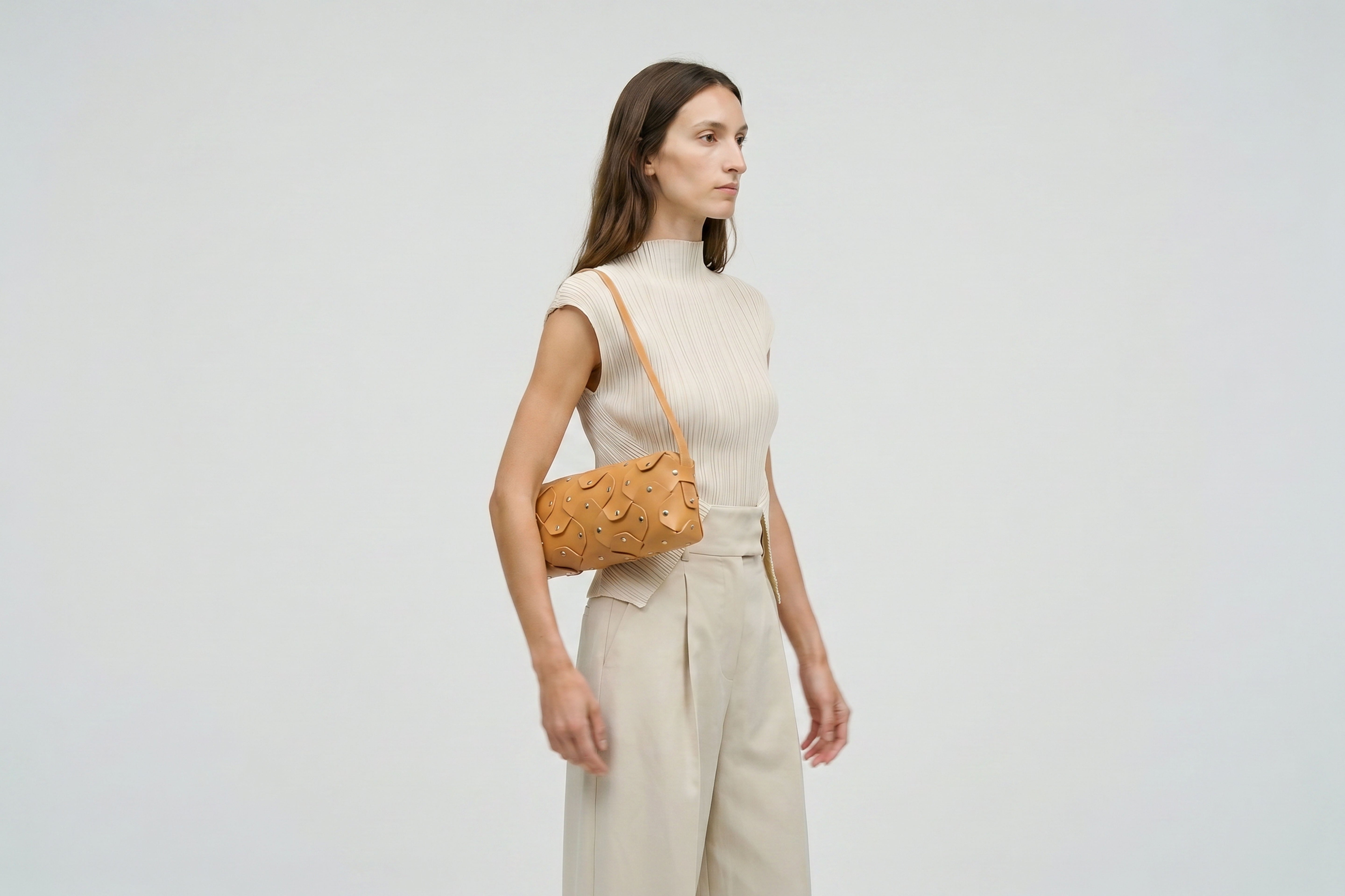 Rivet Bag 01 In Brown Color On A Woman Model In Vegetable Tanned Leather With Brass Rivets Unique Design Atelier Madre Manuel Dreesmann Barcelona Spain