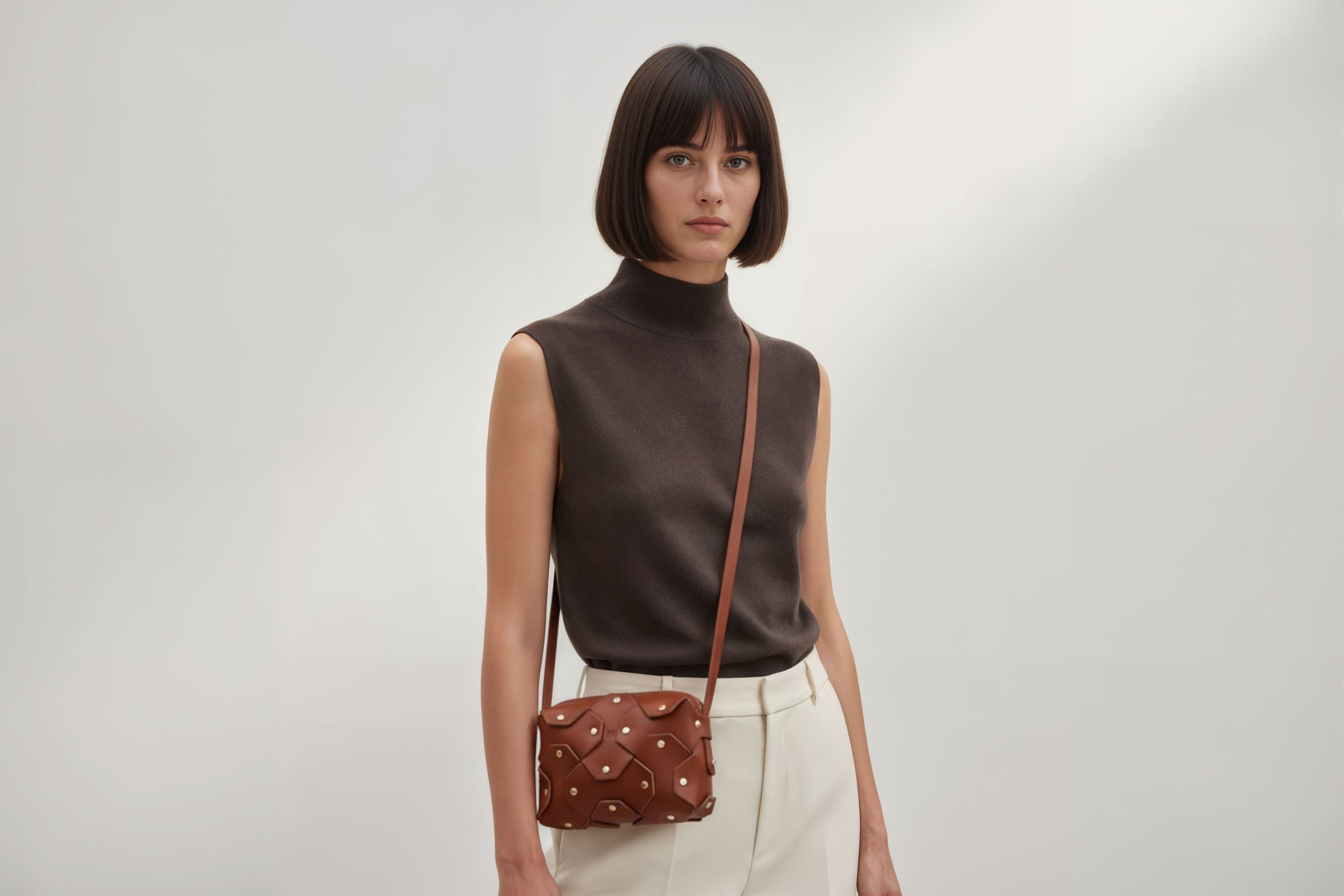 Rivet Bag Small Leather Dark Brown Color Clutch On Model Crossbody Shoulder Detachable Full Brass Vegetable Tanned Full Grain Leather High Quality Modern Minimalistic Design Atelier Madre Manuel Dreesmann Barcelona Spain